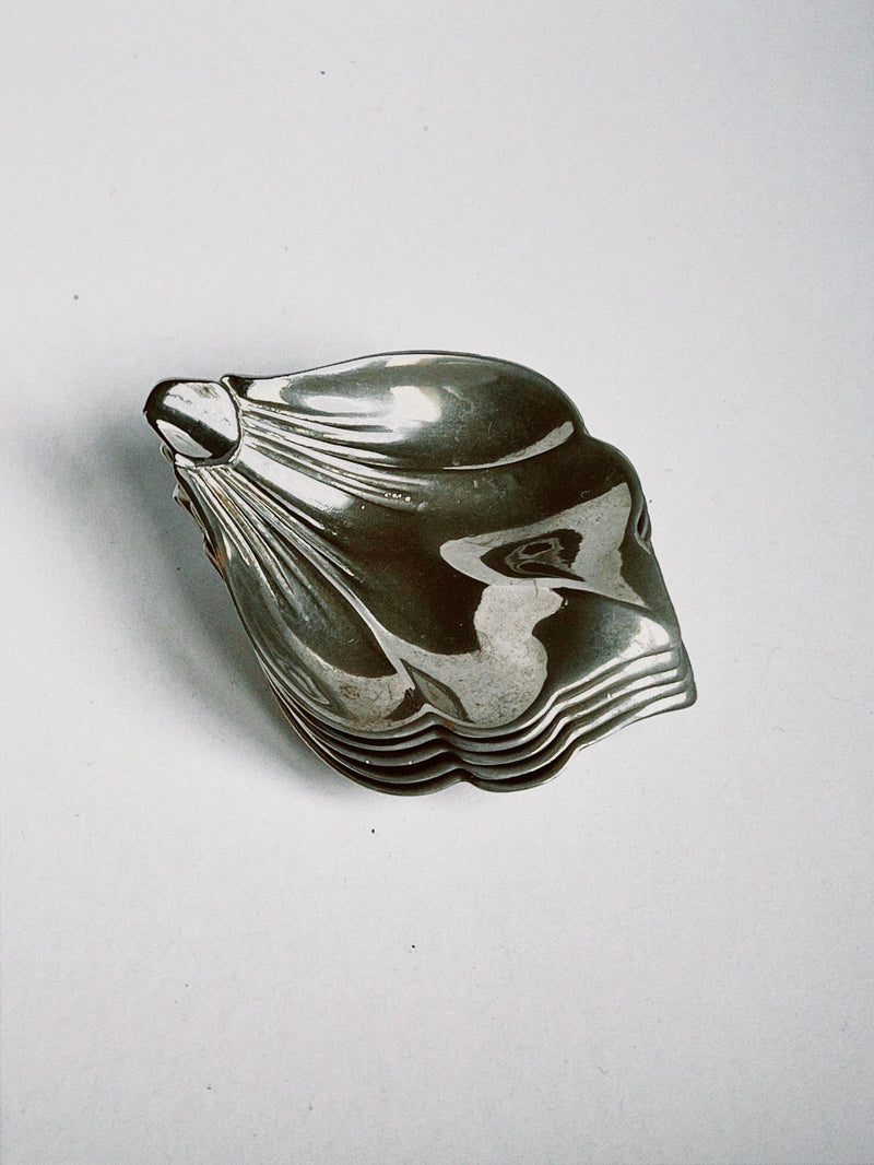 Sculptural silver shell-shaped decorative bowl with organic curves