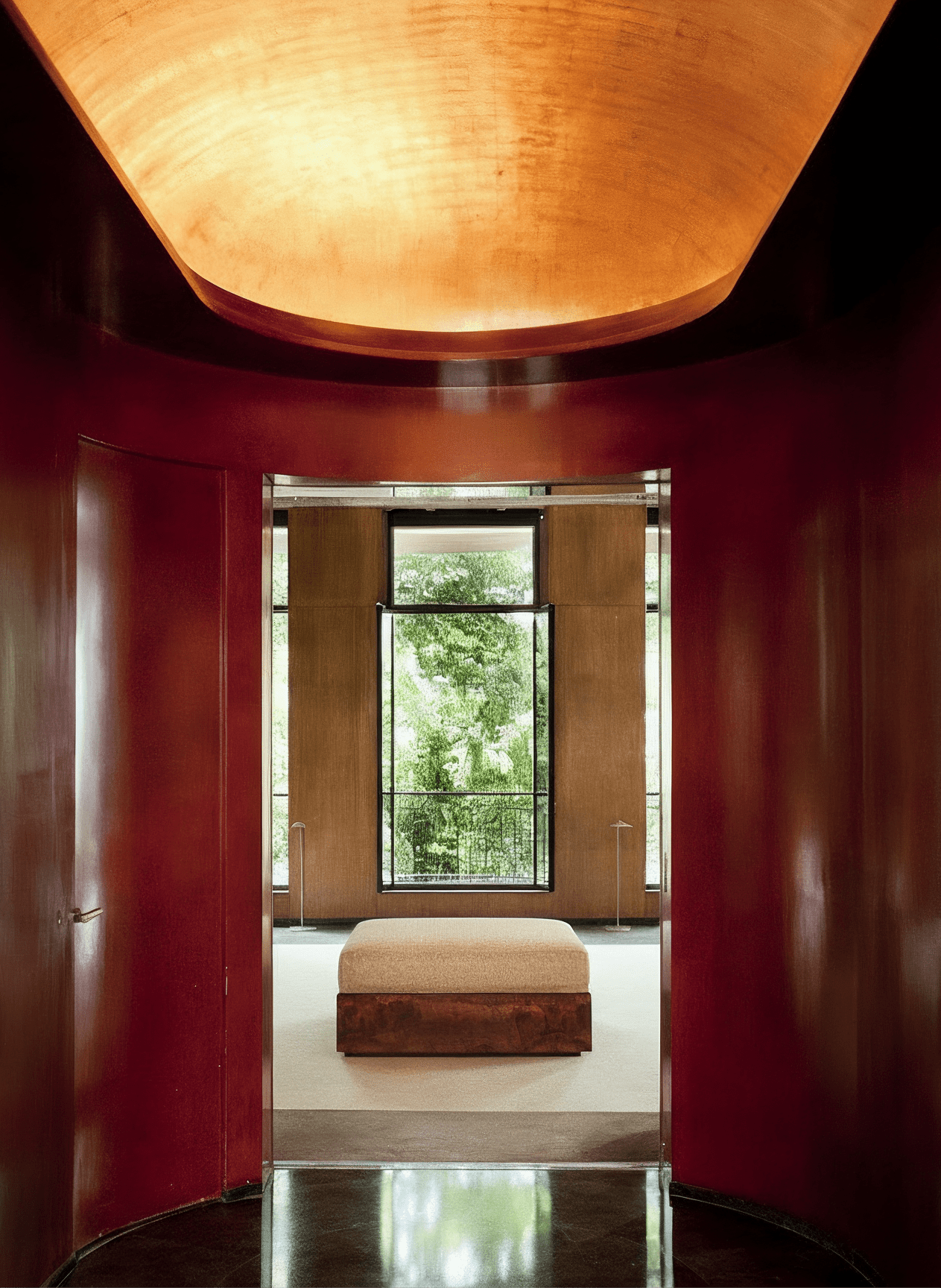KAVA Collection I POUF – Walnut Burl Finish, Dedar Upholstery — positioned in modern hallway with natural light