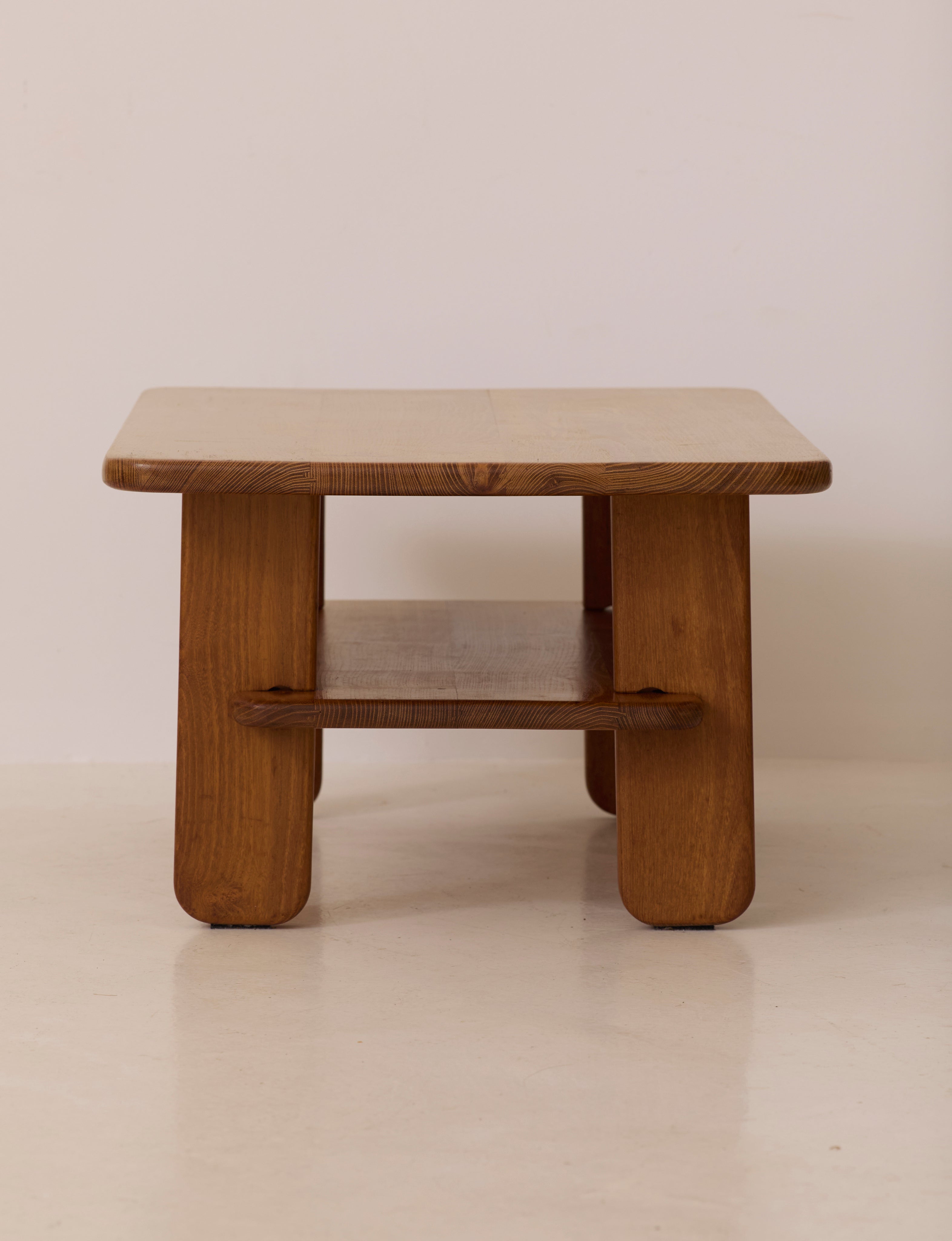 Solid elm coffee table by Alain Gaubert, France circa 1980 — back view highlighting sturdy legs and lower shelf