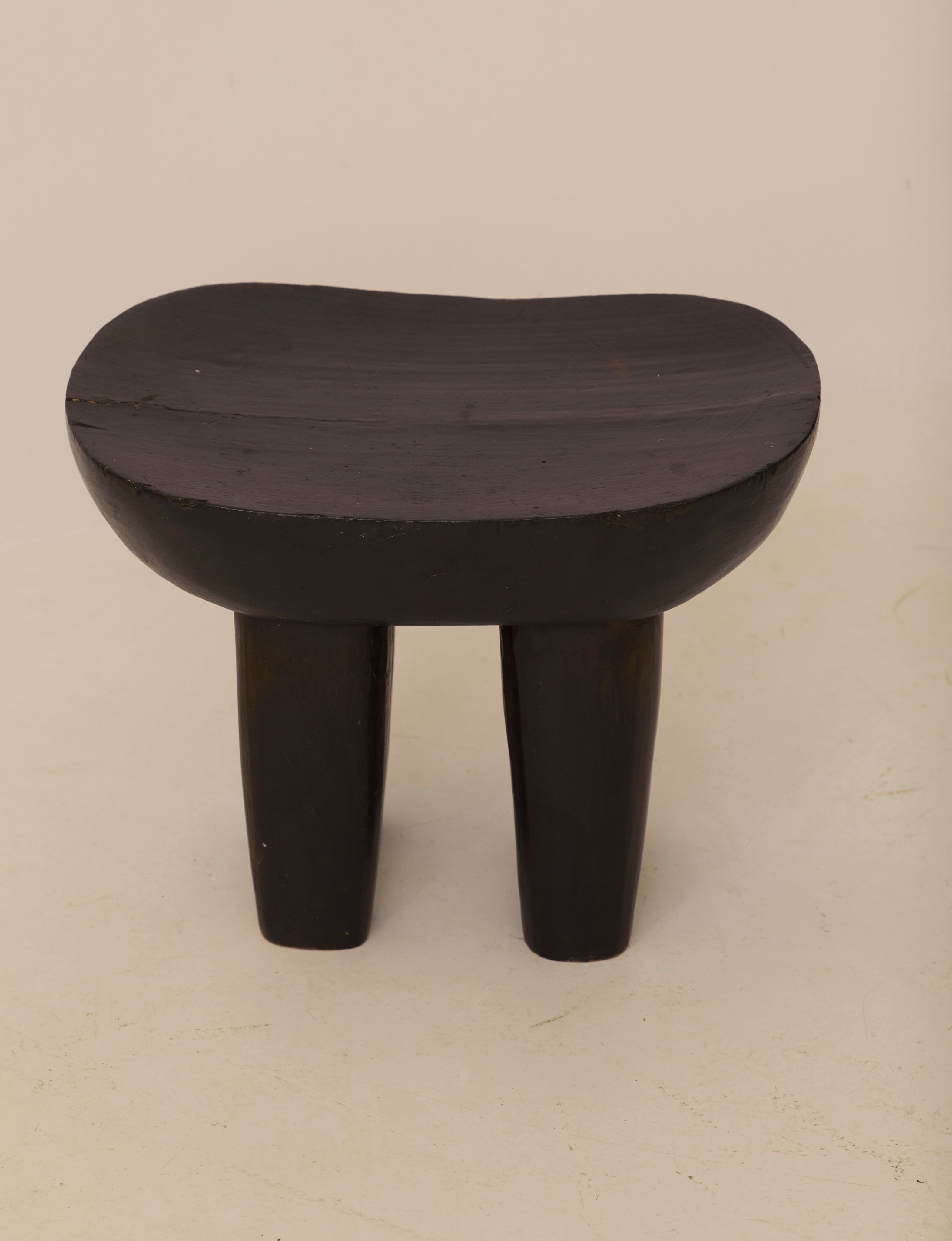 Vintage Senufo Monoxyl African Stool in Black / Wenge — side angle showing curved seat and legs