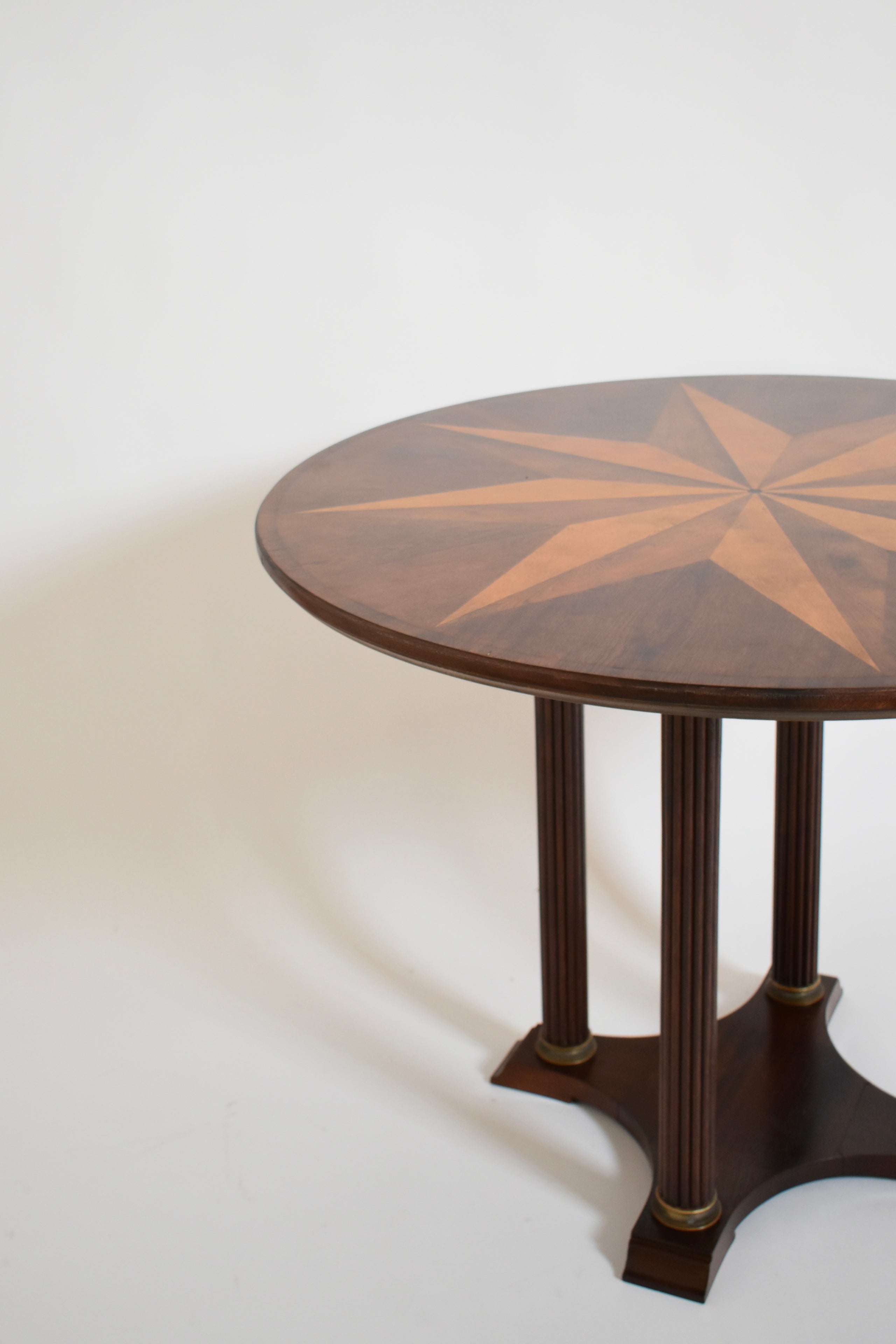 Neoclassical Star Marquetry Pedestal Table — angled view highlighting wood grain and star design
