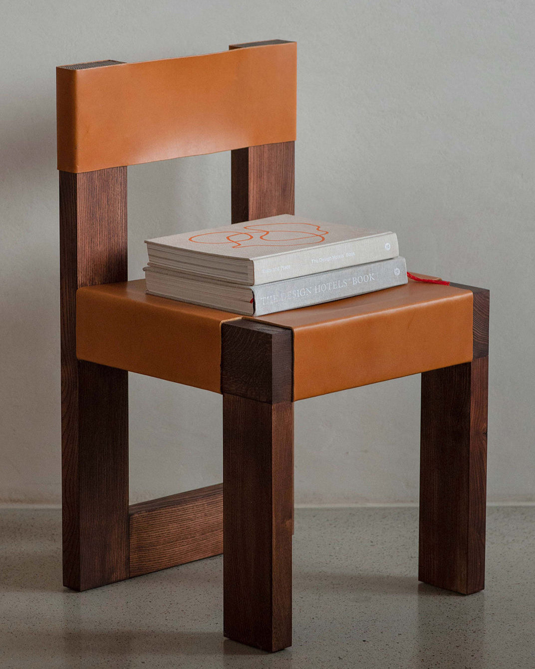 Chair object118 — side angle showing orange leather seat and wooden frame