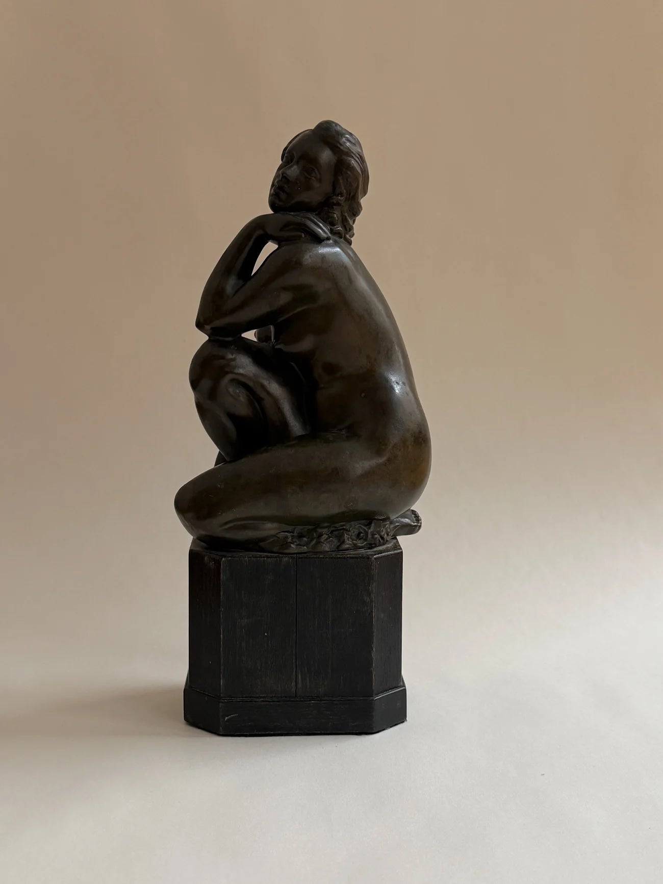 Bronze Sculpture of a Seated Woman — rear view highlighting smooth bronze finish
