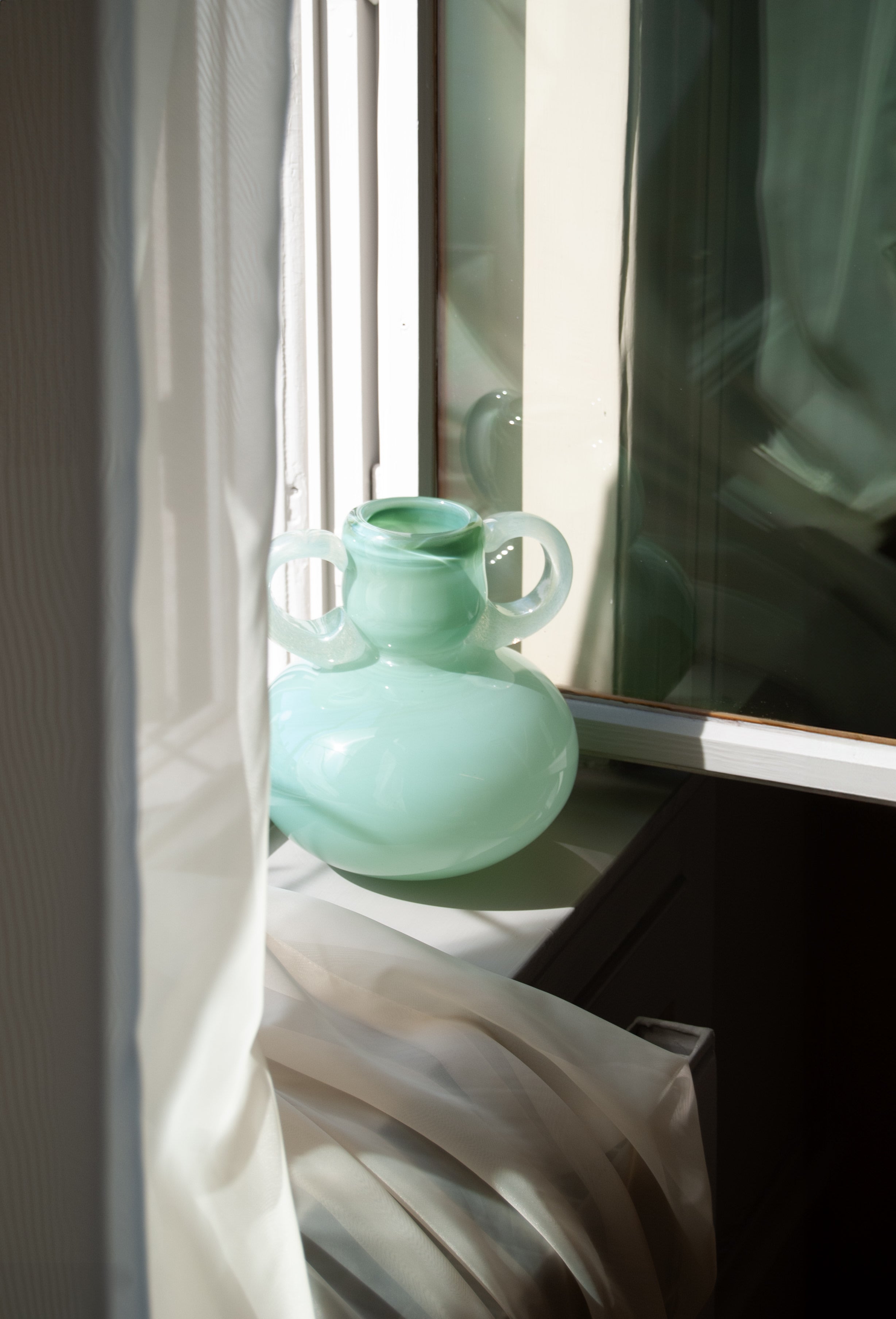 The Vase 03 — mint green glass vase on windowsill