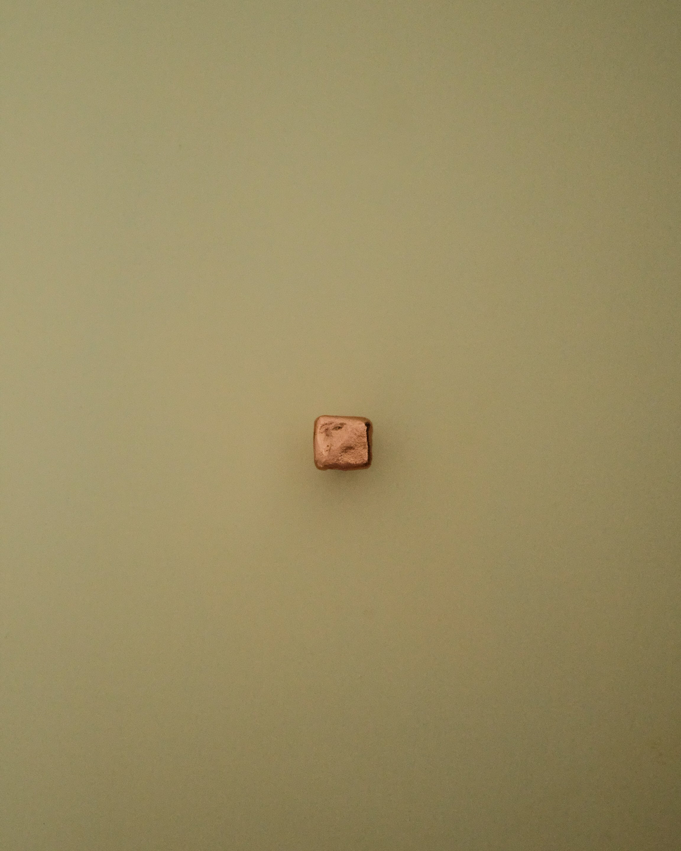 ISLE Cabinet Knob/Wall Hook Small — back view against green wall