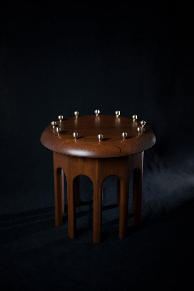 Corona Side Table — close-up of wooden surface with brass accents