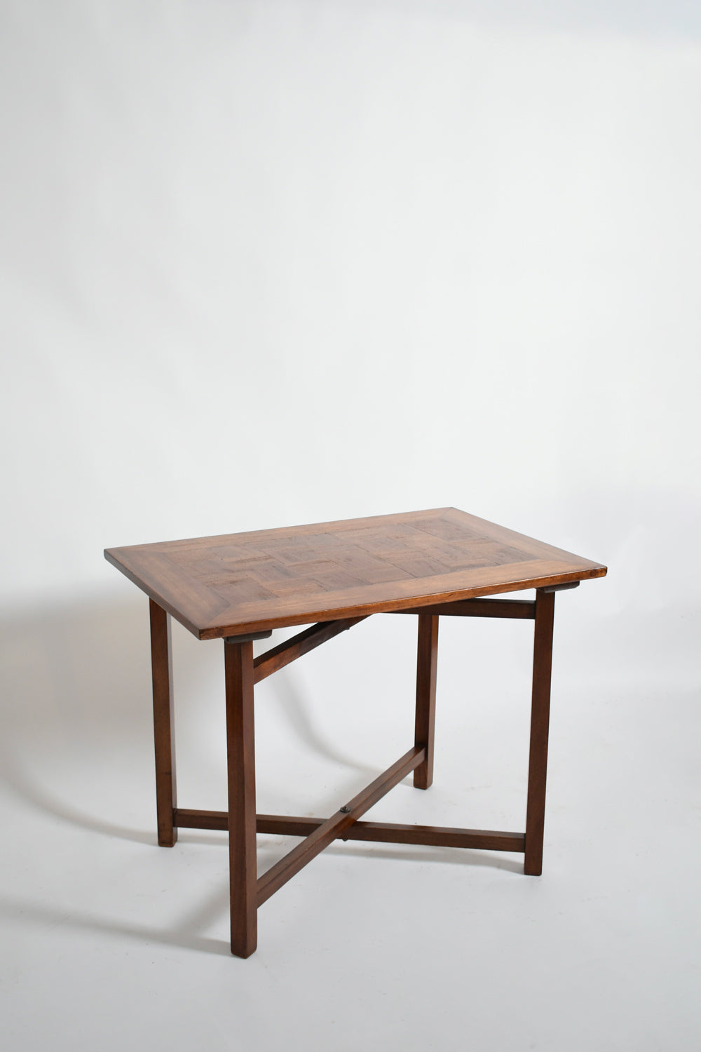 X Shaped Foot Chessboard Table, XIXth c. — angled view showing wooden surface and legs