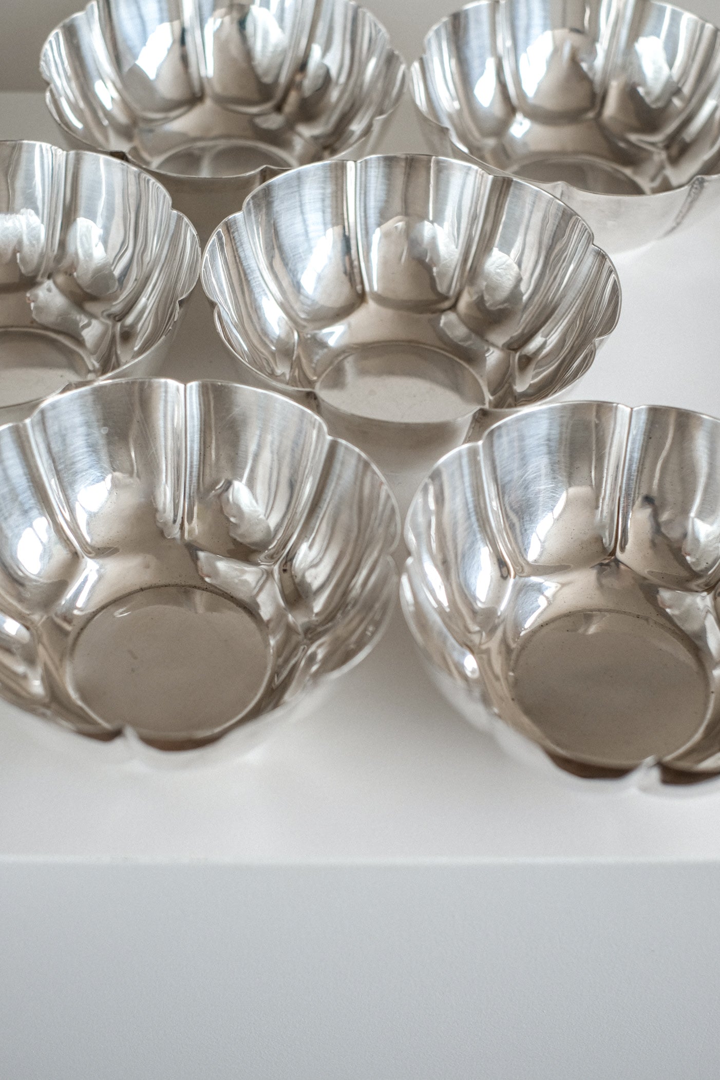 Set of 6 Silver-Plated Bowls 1960s — top view showing reflective surfaces on white background