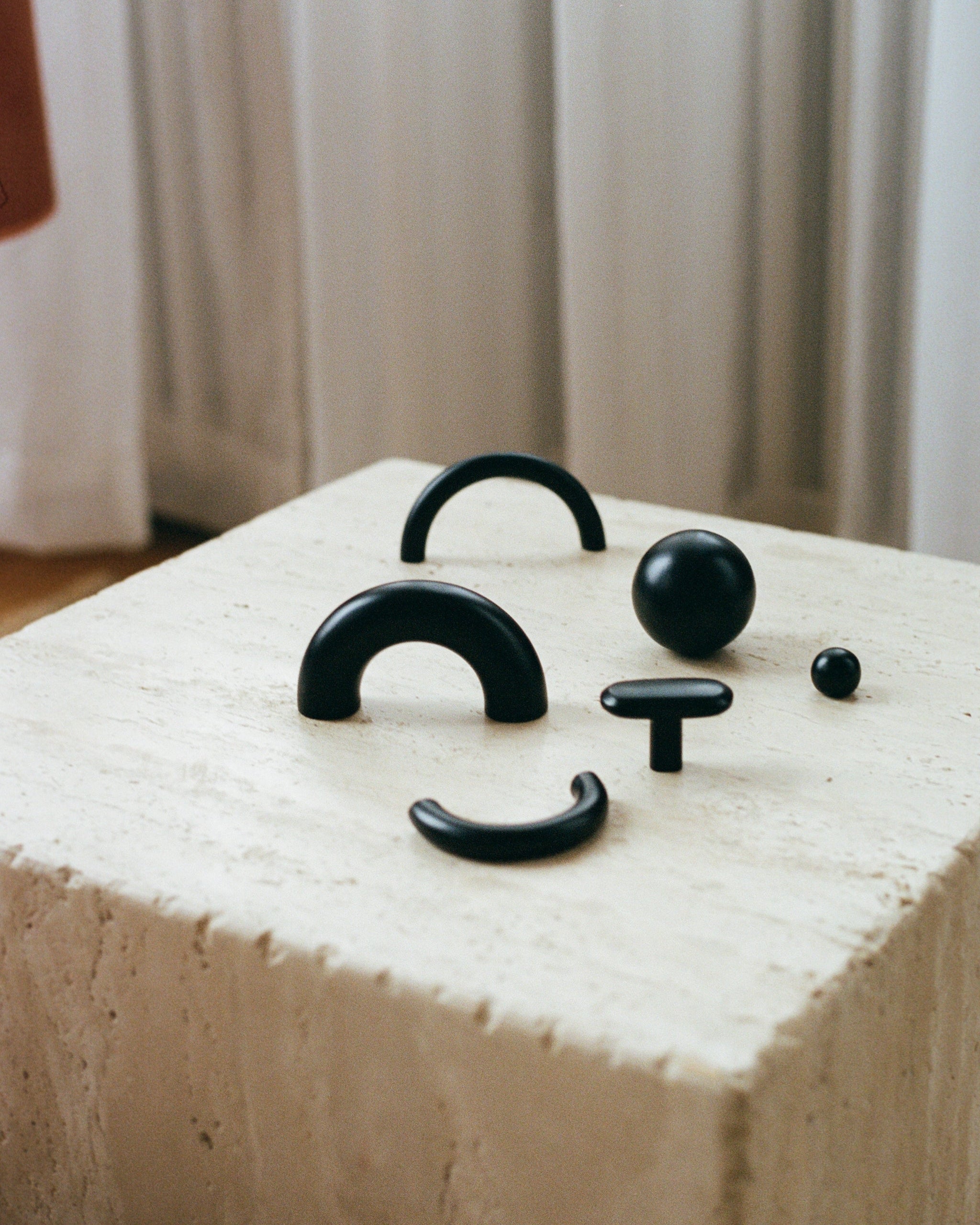 CERCLE Cabinet Pull Thick — back view of black knobs on textured surface