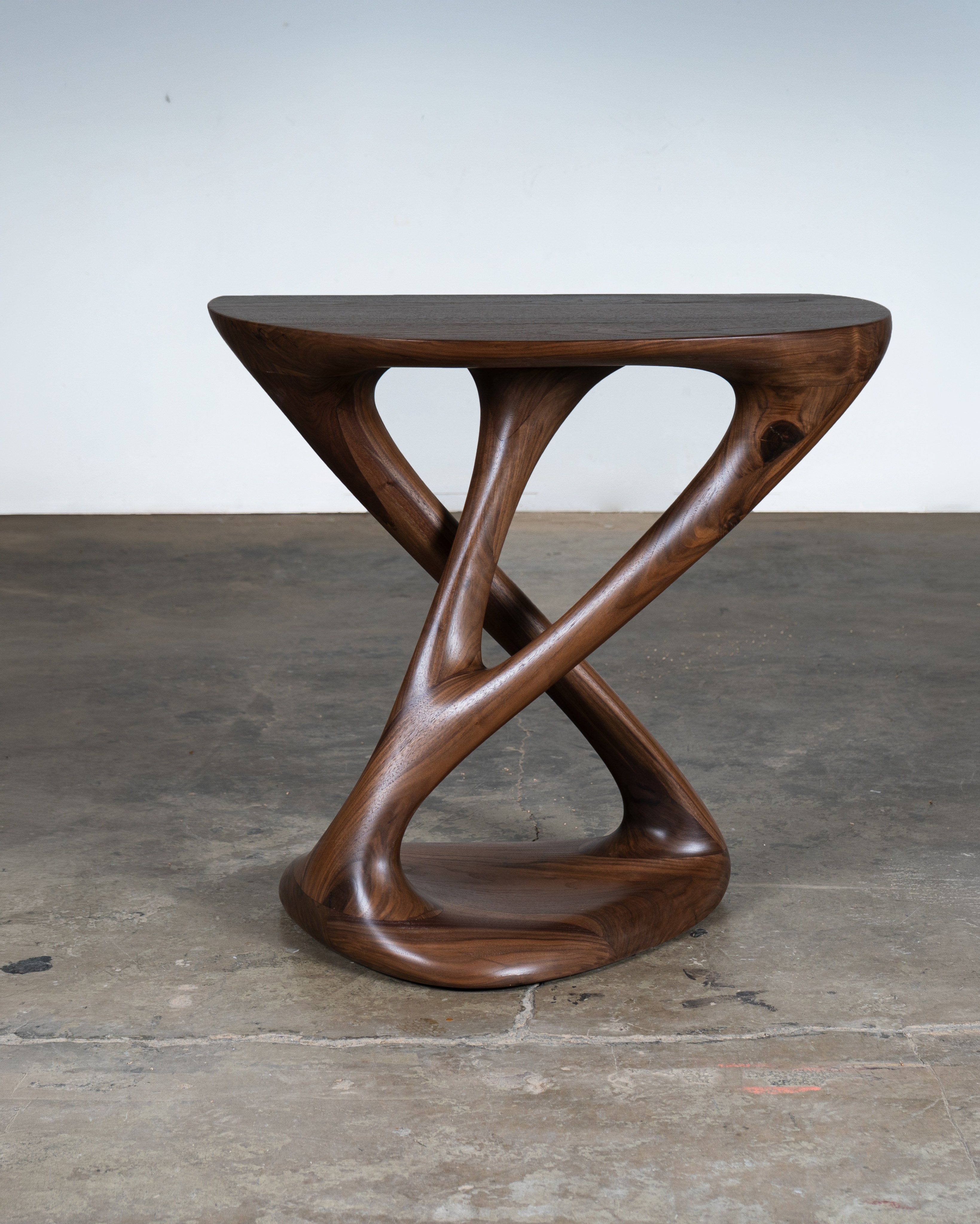 Kova Console in Walnut wood Natural Stain — side view highlighting curved wooden design