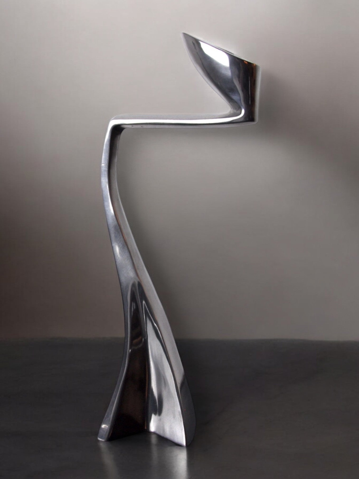 Swan Candleholder by Matthew Hilton, England, 1980 — side angle highlighting polished metal finish