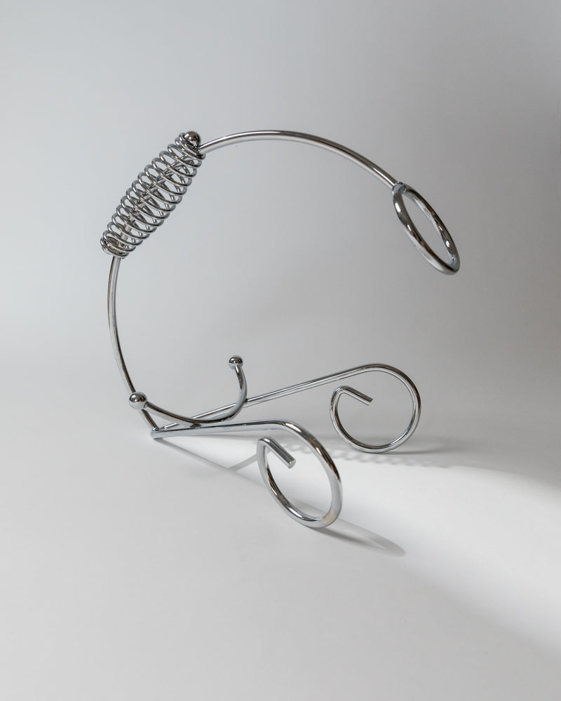 Chrome wire bottle holder with spiral coil and curved stand, 1980s