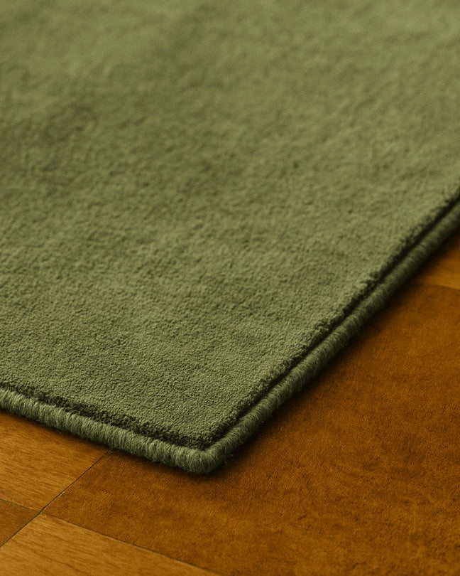 Rug 100% Wool New Zealand - Sauge — side angle showing soft green texture on wood floor