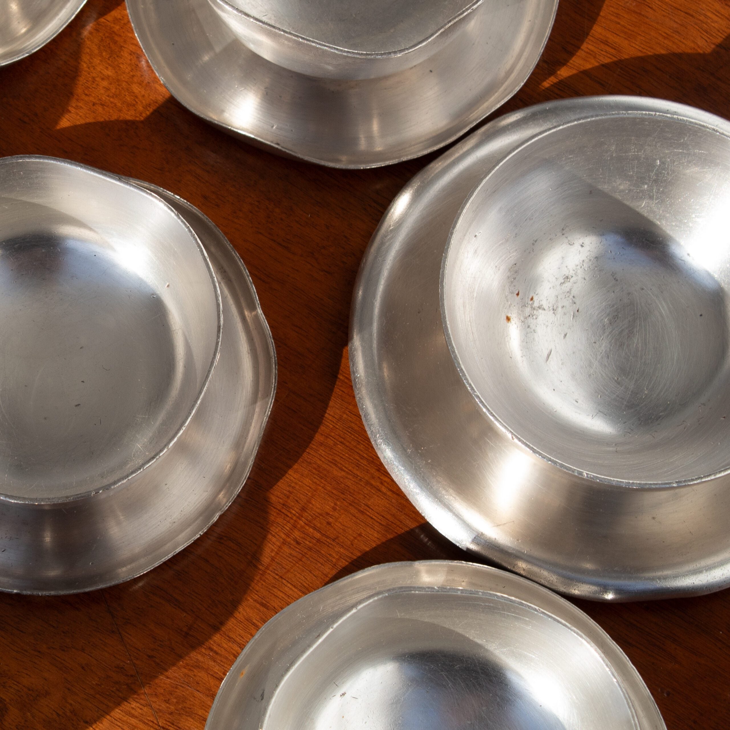 Metal Serving Bowl - Arthur Krupp — overhead view of aluminum bowls on wooden table