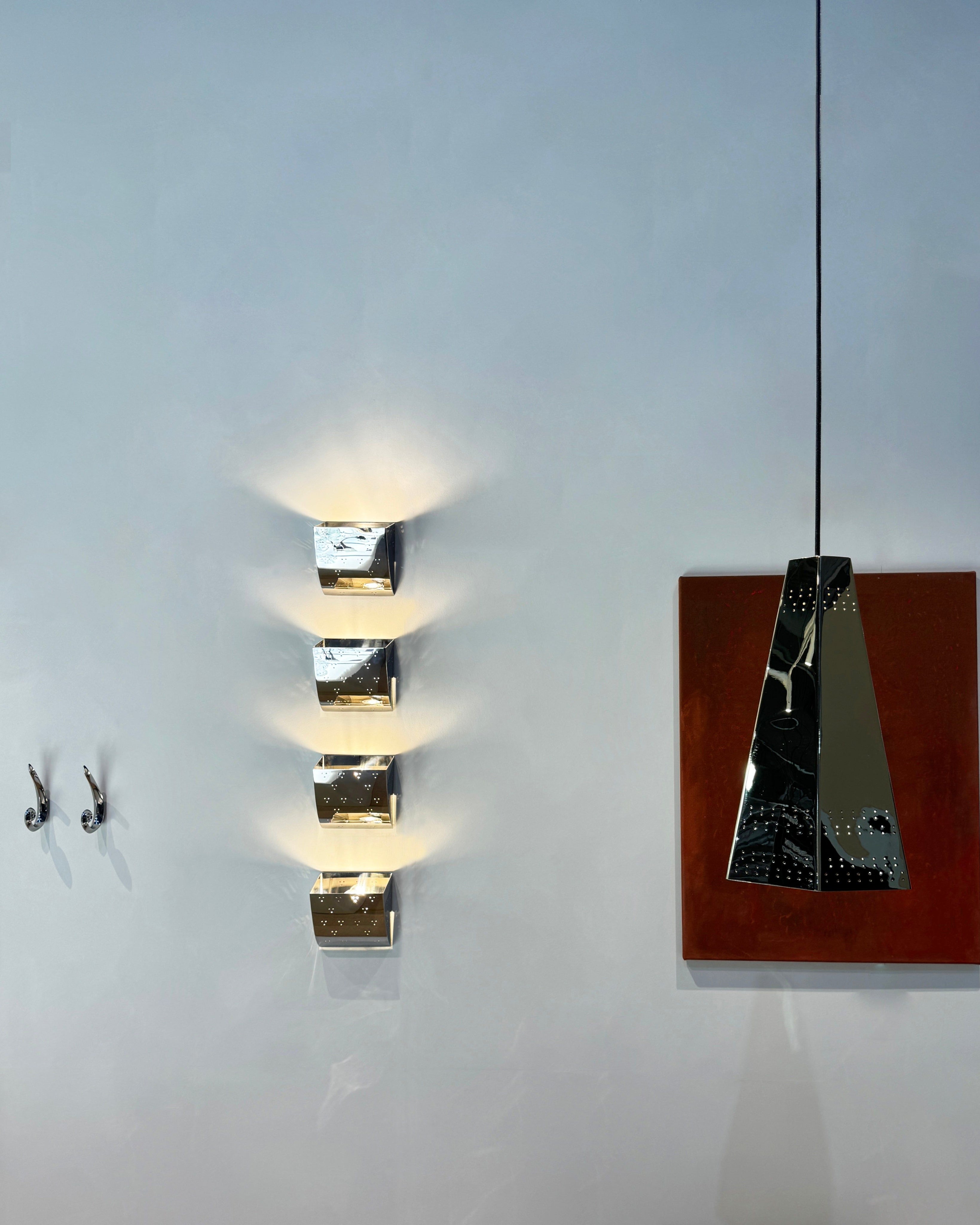 Jolene Wall Lamp - Polished Steel — mounted on wall in modern interior