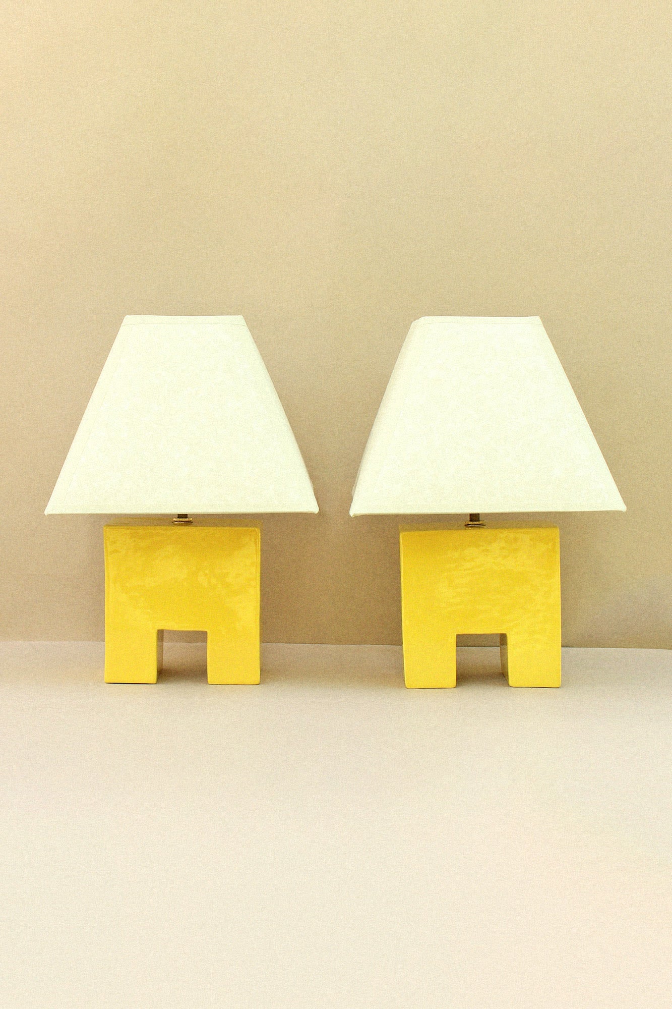 Cristo Lamp (Sol) — two yellow lamps with white shades on neutral background
