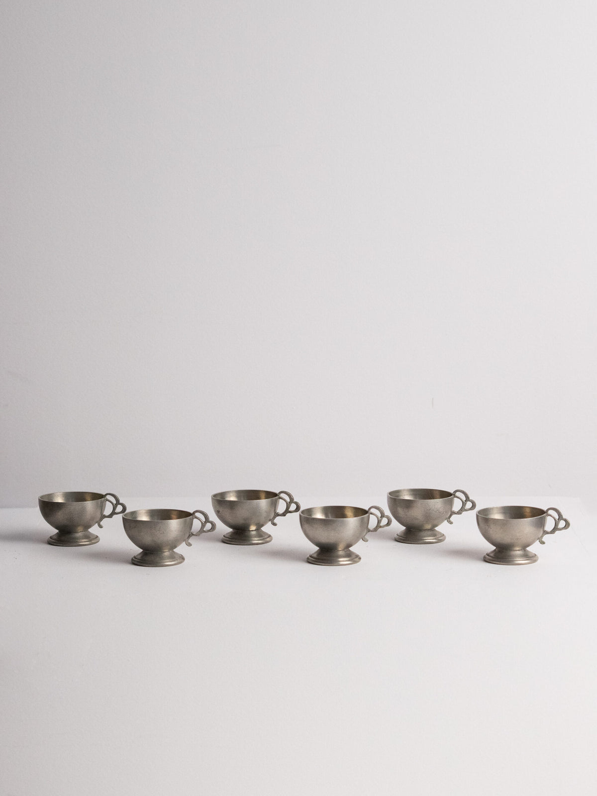 Six Footed Pewter Punch Cups, Triple-Loop Handles, Sweden 1977 by Studio Ecubed | The Oblist