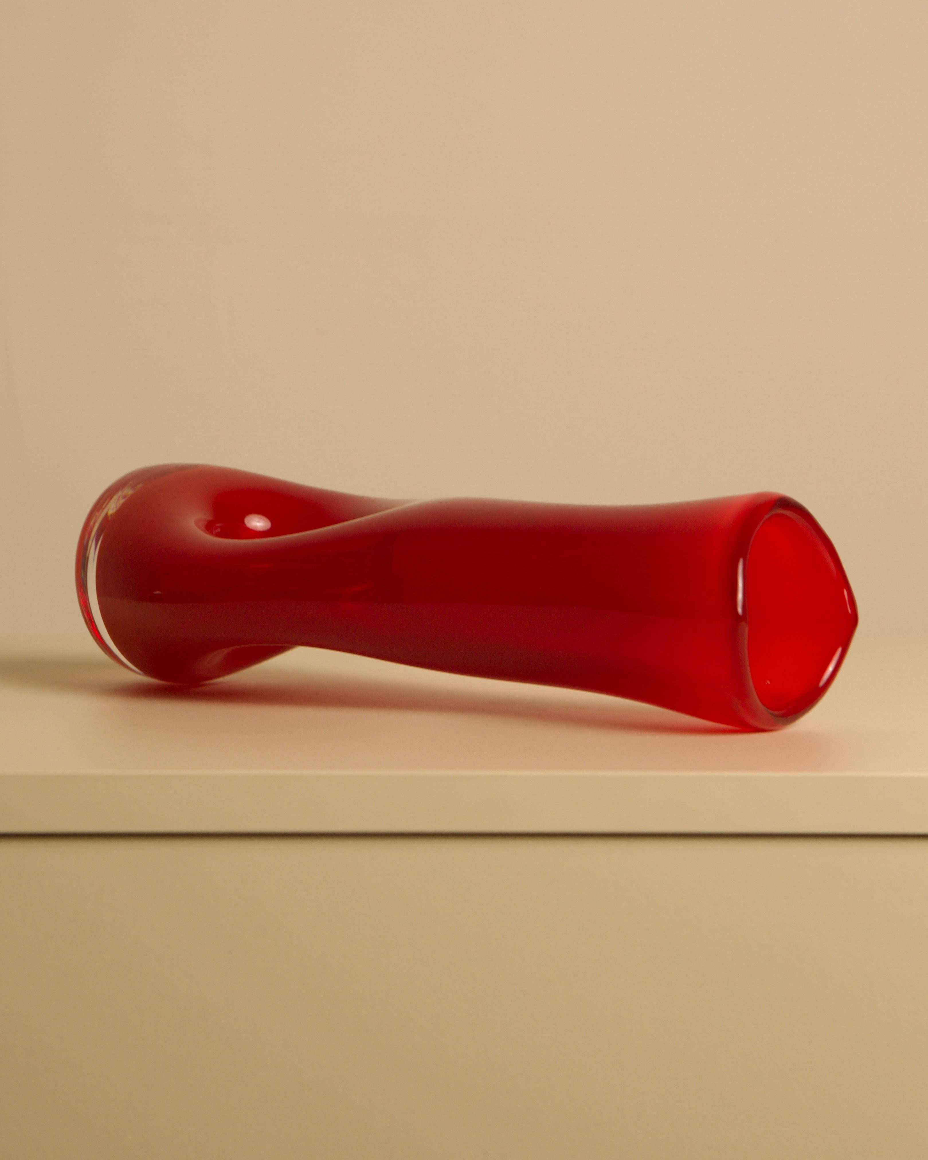 Red "Percé" Vase in Murano Glass from the 80s — angled view on white shelf
