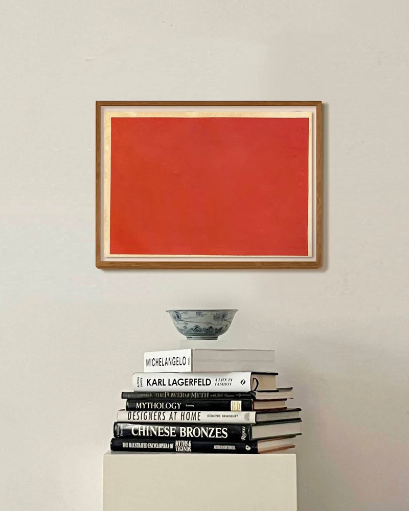 Three Layers of French Red Dye and Pigment on Aged Paper — framed artwork above stacked books