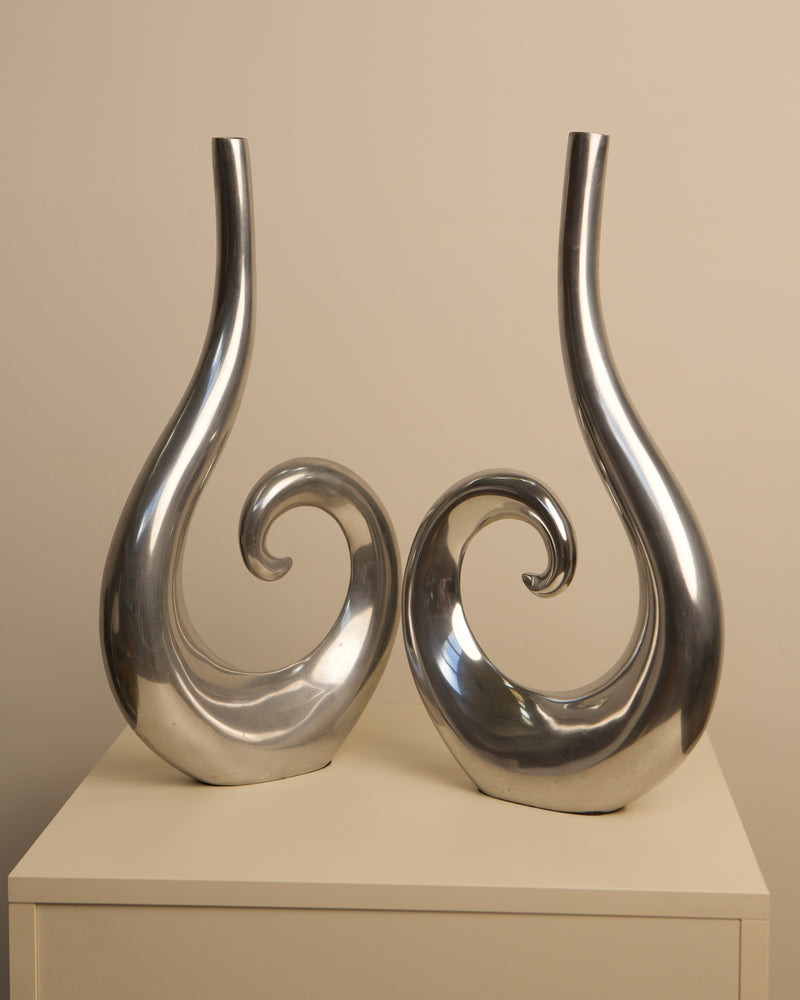Pair of sleek Italian aluminum vases with curved spiral design 1980s