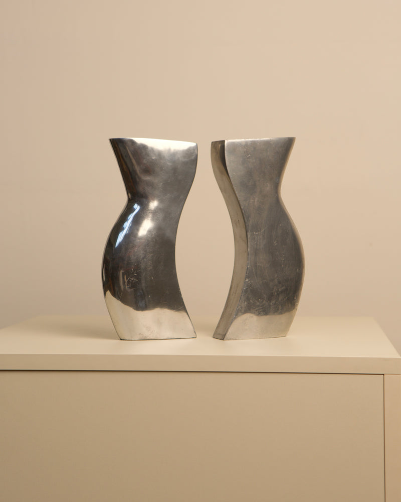 Pair of curved aluminum Dance vases showing sculptural profile
