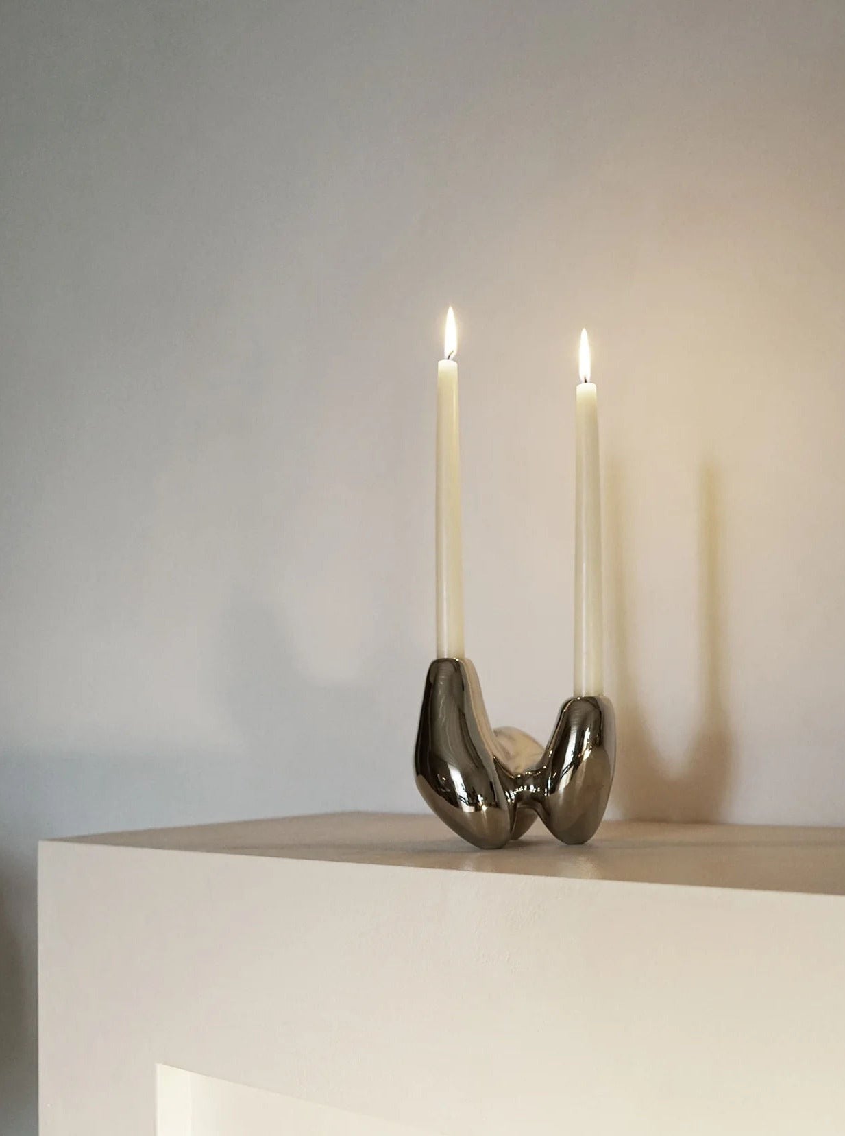 Unity Candleholder - Silver — close-up of polished silver surface with candles