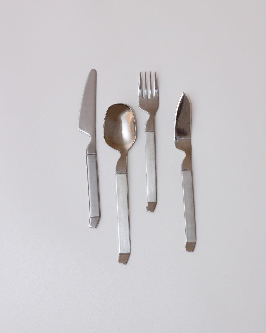 Stainless Steel Cutlery Set — close-up of polished utensils on white background