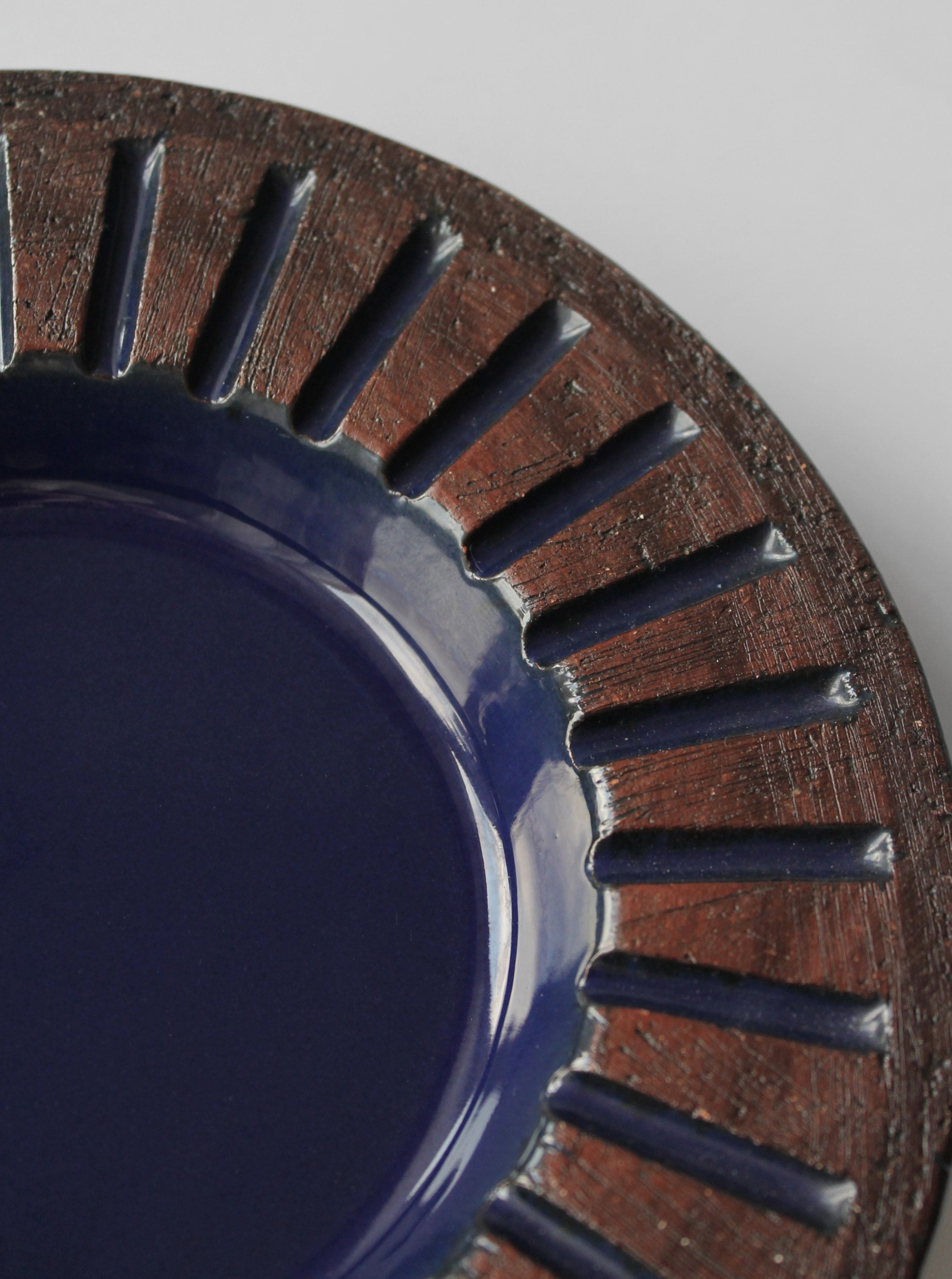 Ingegärd Burmeister Decorative Ceramic Plate — side angle showing deep blue glaze