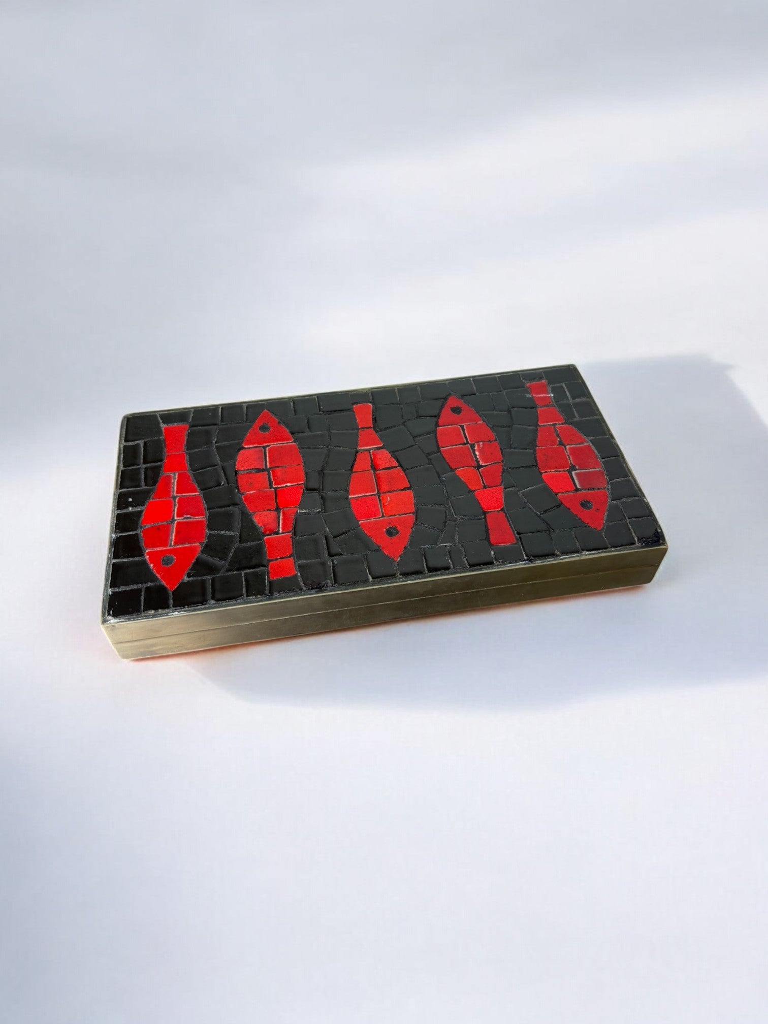 Italian 1960s Fish Mosaic Trinket Box in Ceramic and Brass — side angle showing red fish design on black surface