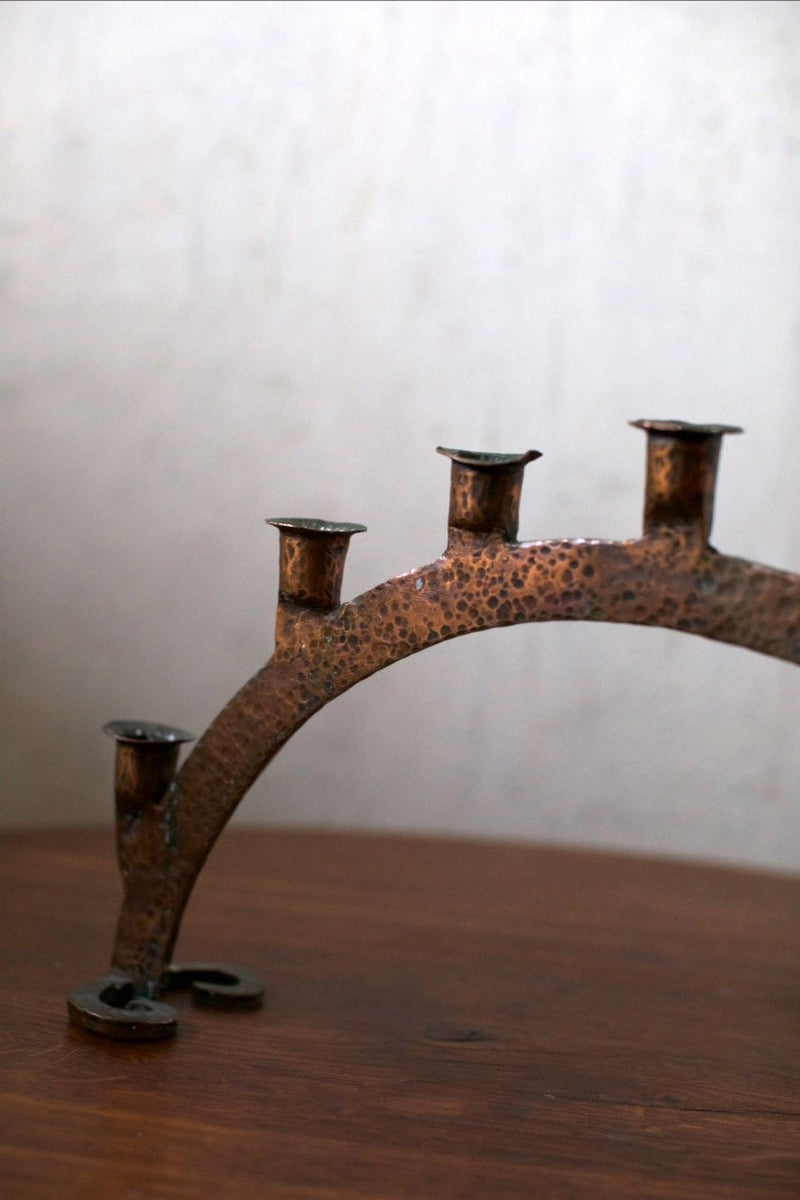 Bronze Candleholder — close-up of hammered bronze surface on wooden table