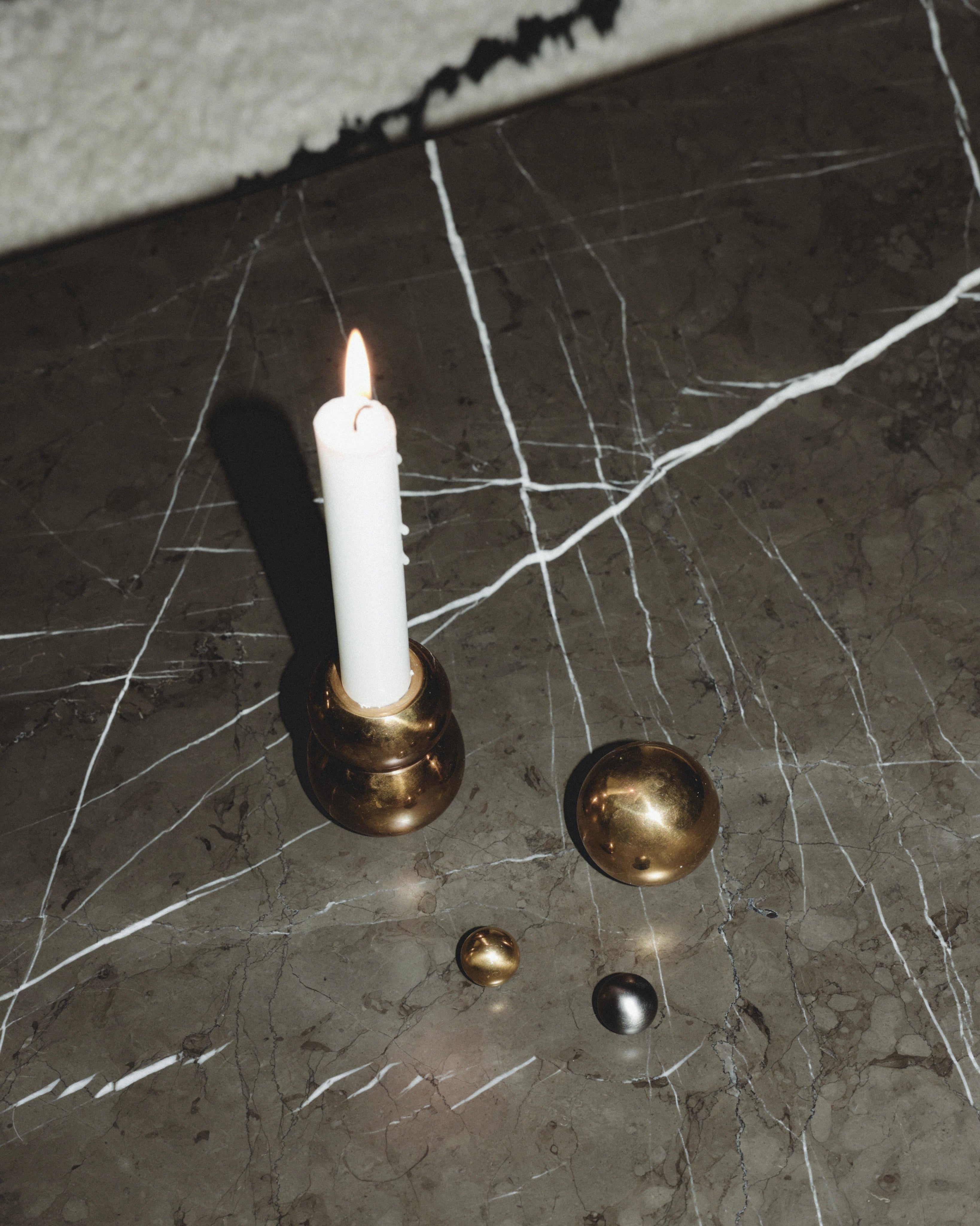 CERCLE Cabinet Knob Small — brass knob on marble surface with candle