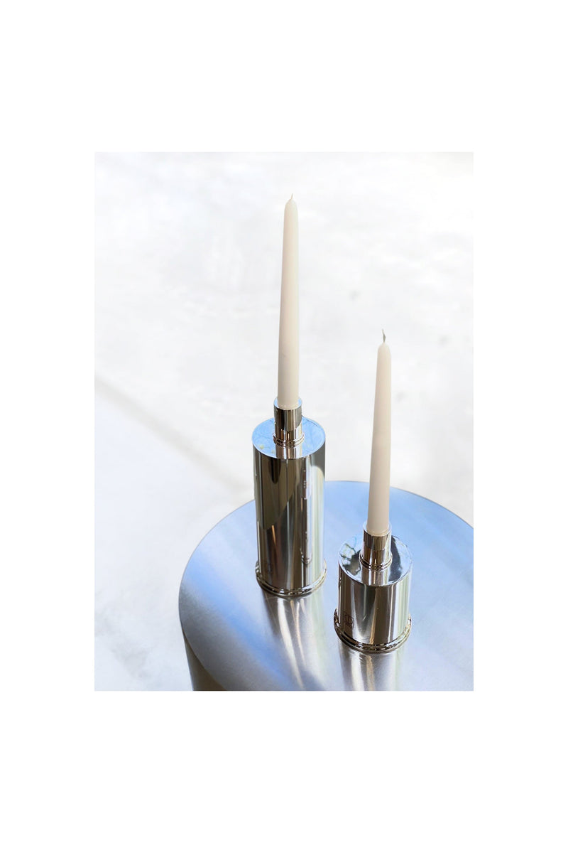 Silver Plated Candle Holders in Brass and Silver Plated Brass — close-up on polished silver surface with candles