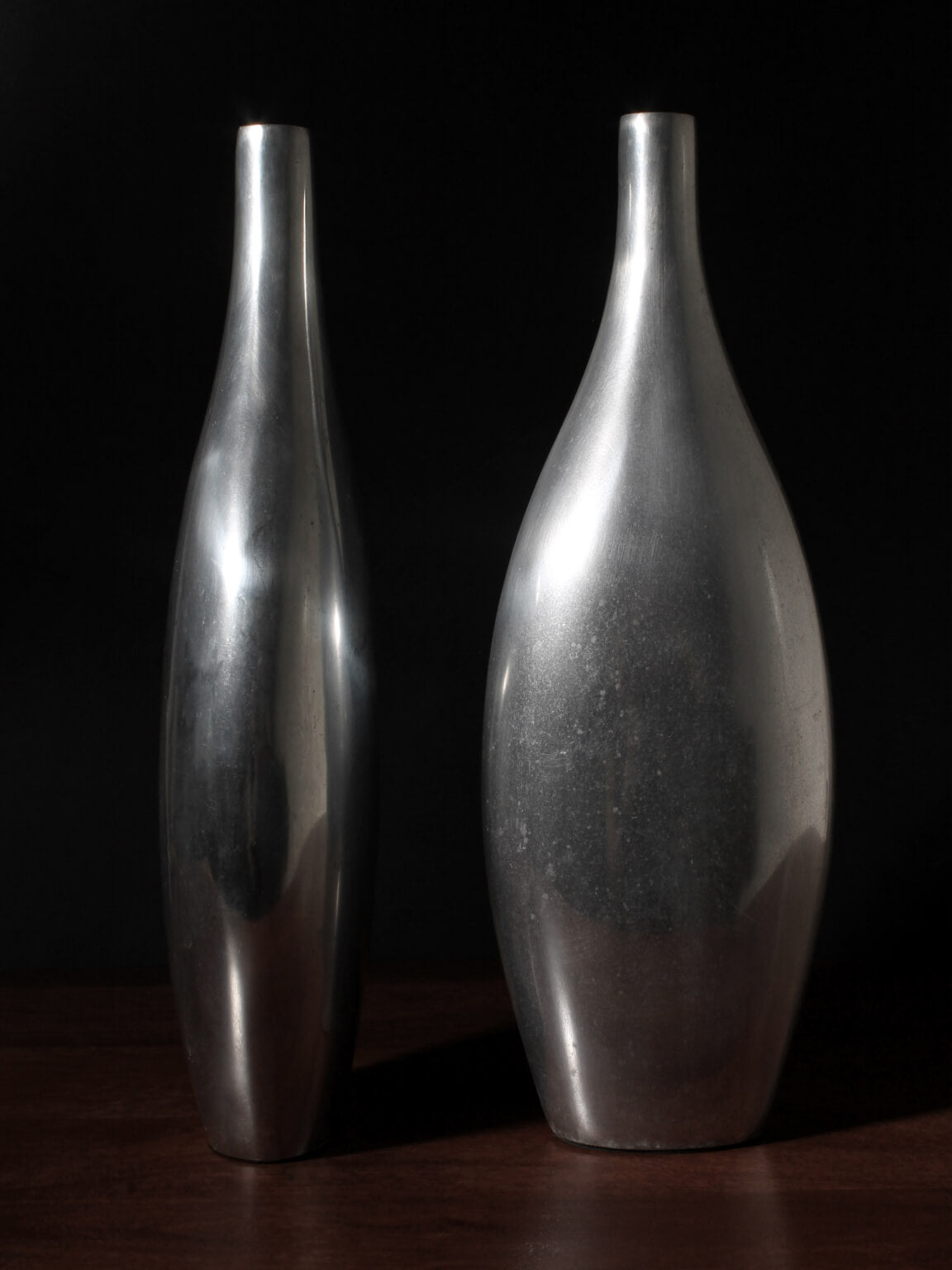 Pair Of Polished Aluminum Tall Vases — lifestyle setting