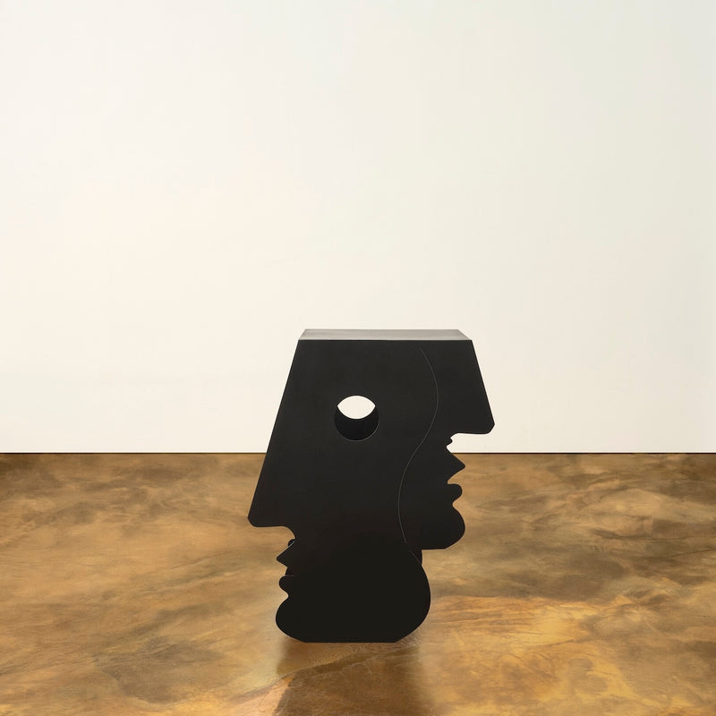 Lucia Side Table — close-up of black sculptural design on gold floor