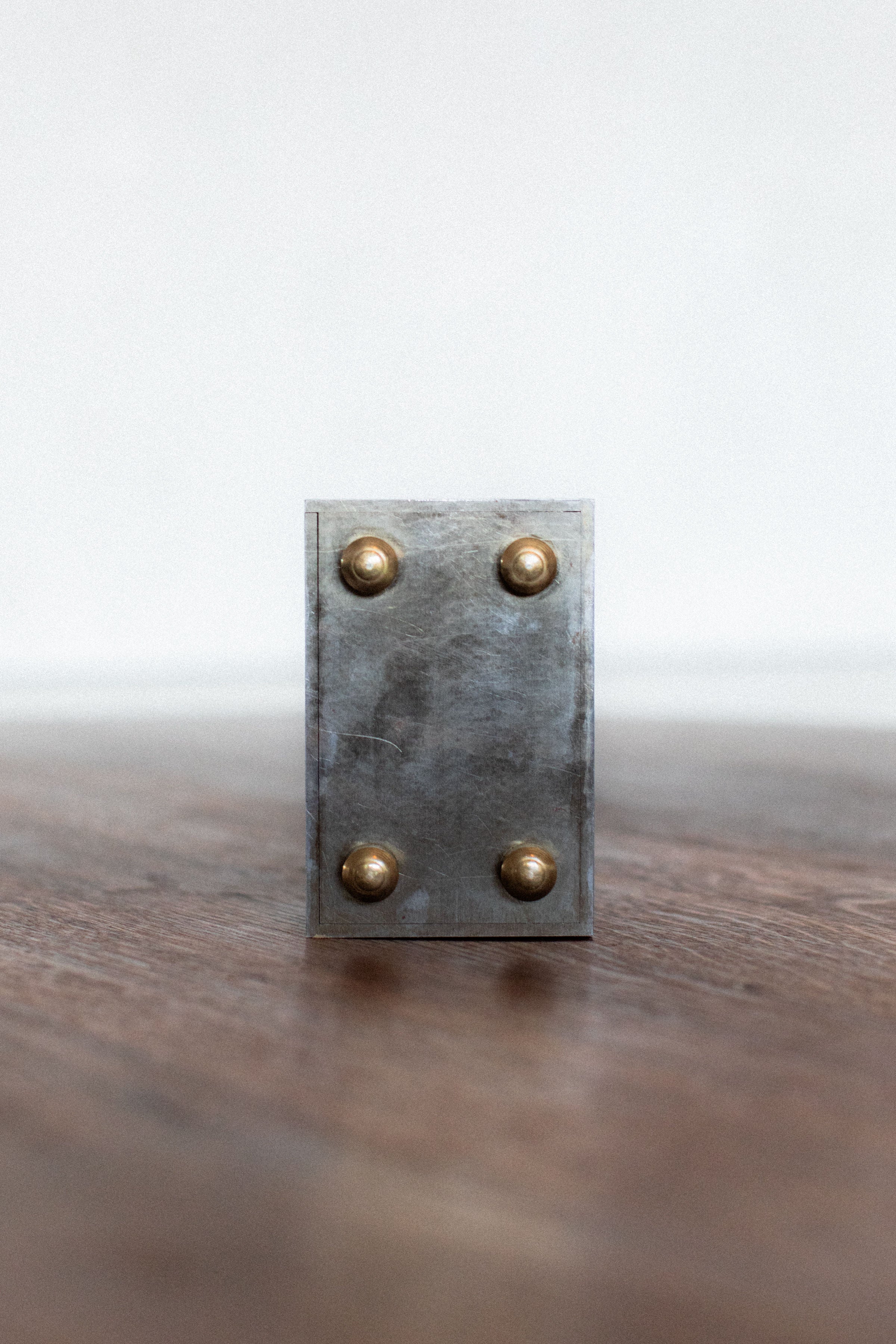 Industrial zinc metal box with brass rivets detail view