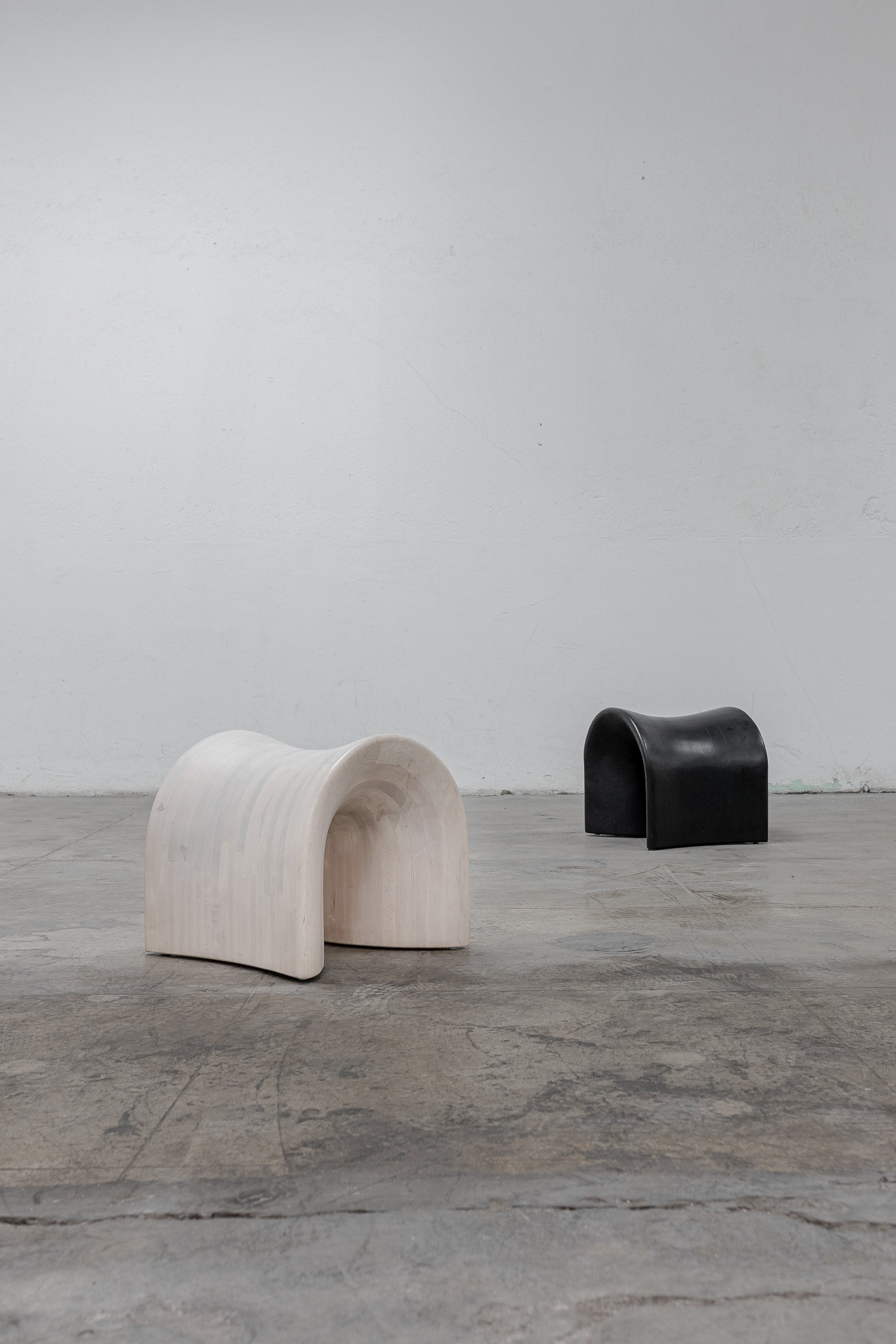 TORO Oak Stool — two stools in minimalist setting on concrete floor