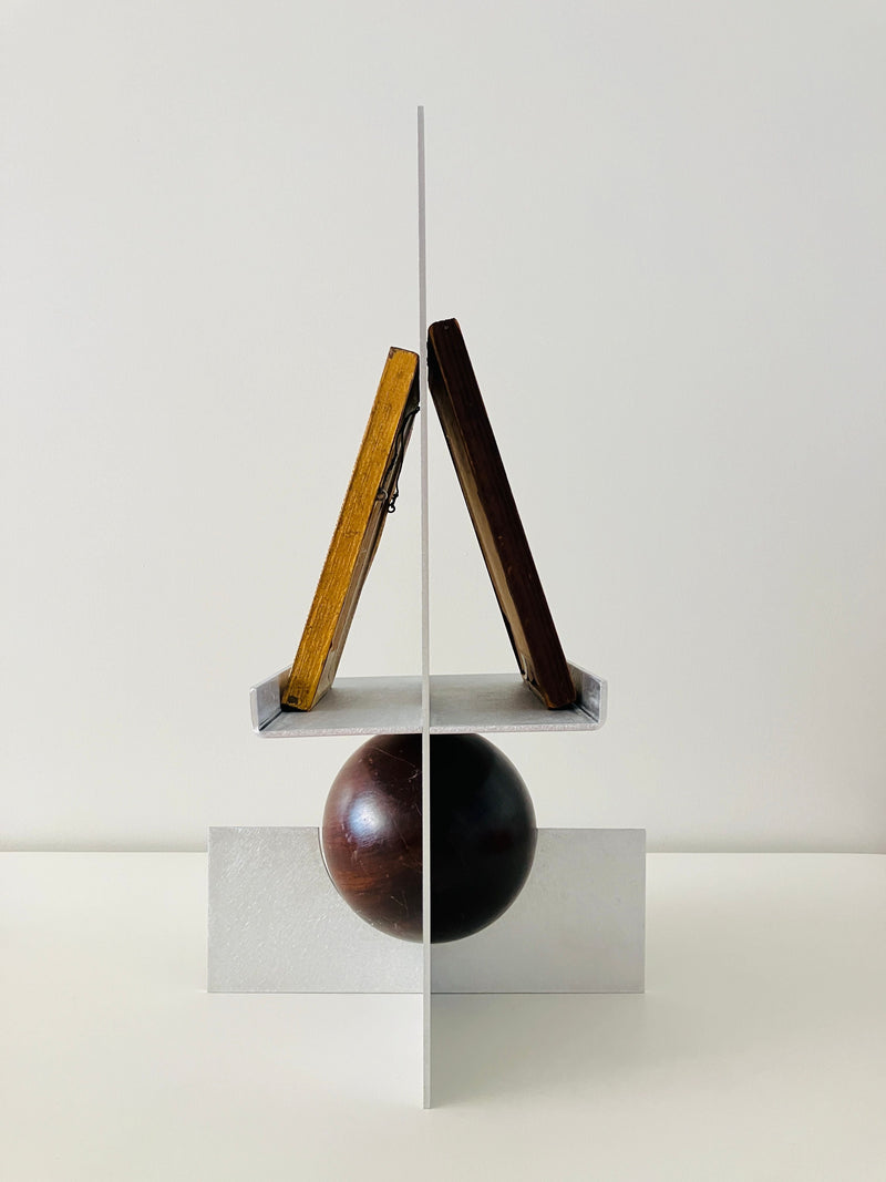 Modern wooden easel frame with dark sphere on clear acrylic base