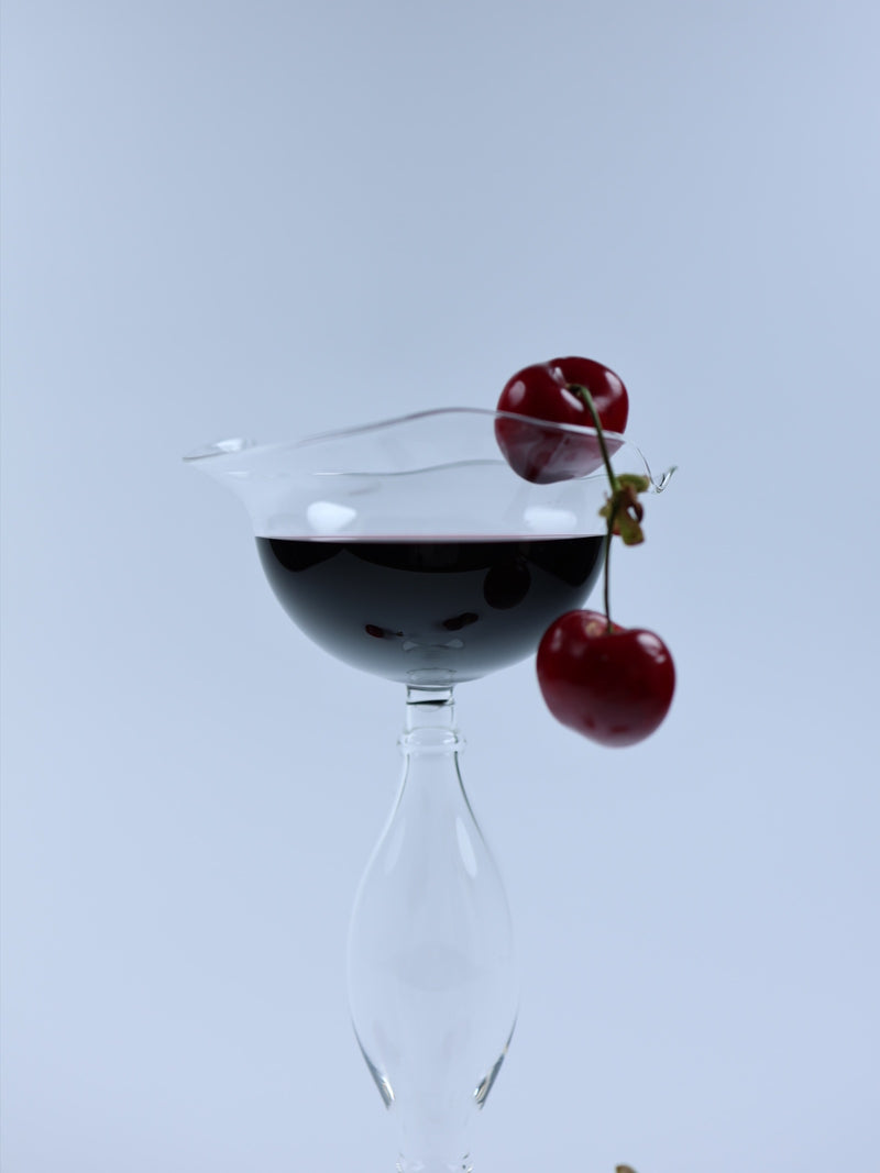 Crater wine glass with cherries showing distinctive layered design
