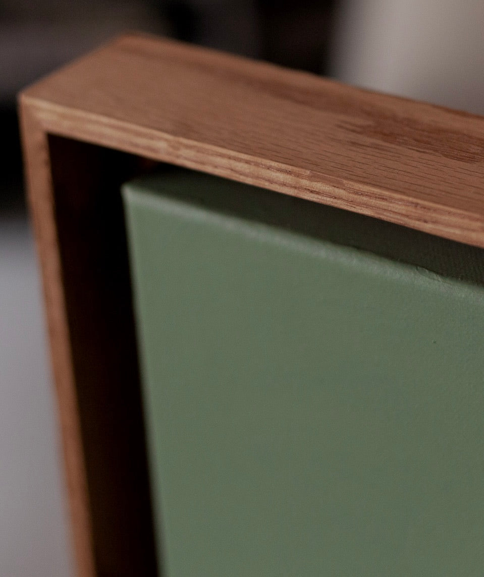 Beneath' Painting — top view of green canvas in wooden frame