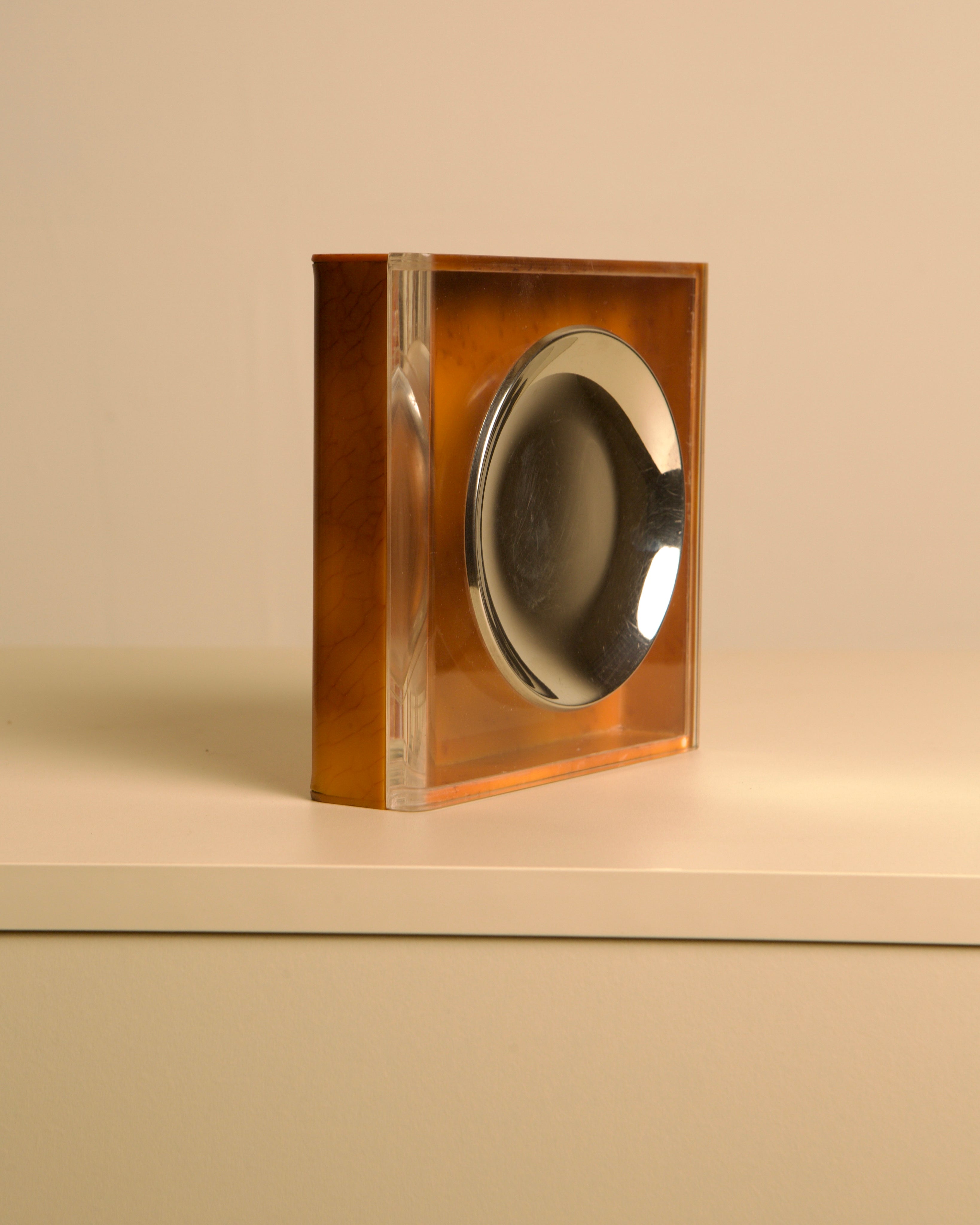 Italian 70s trinket tray and box in brown bakelite — angled view on white surface
