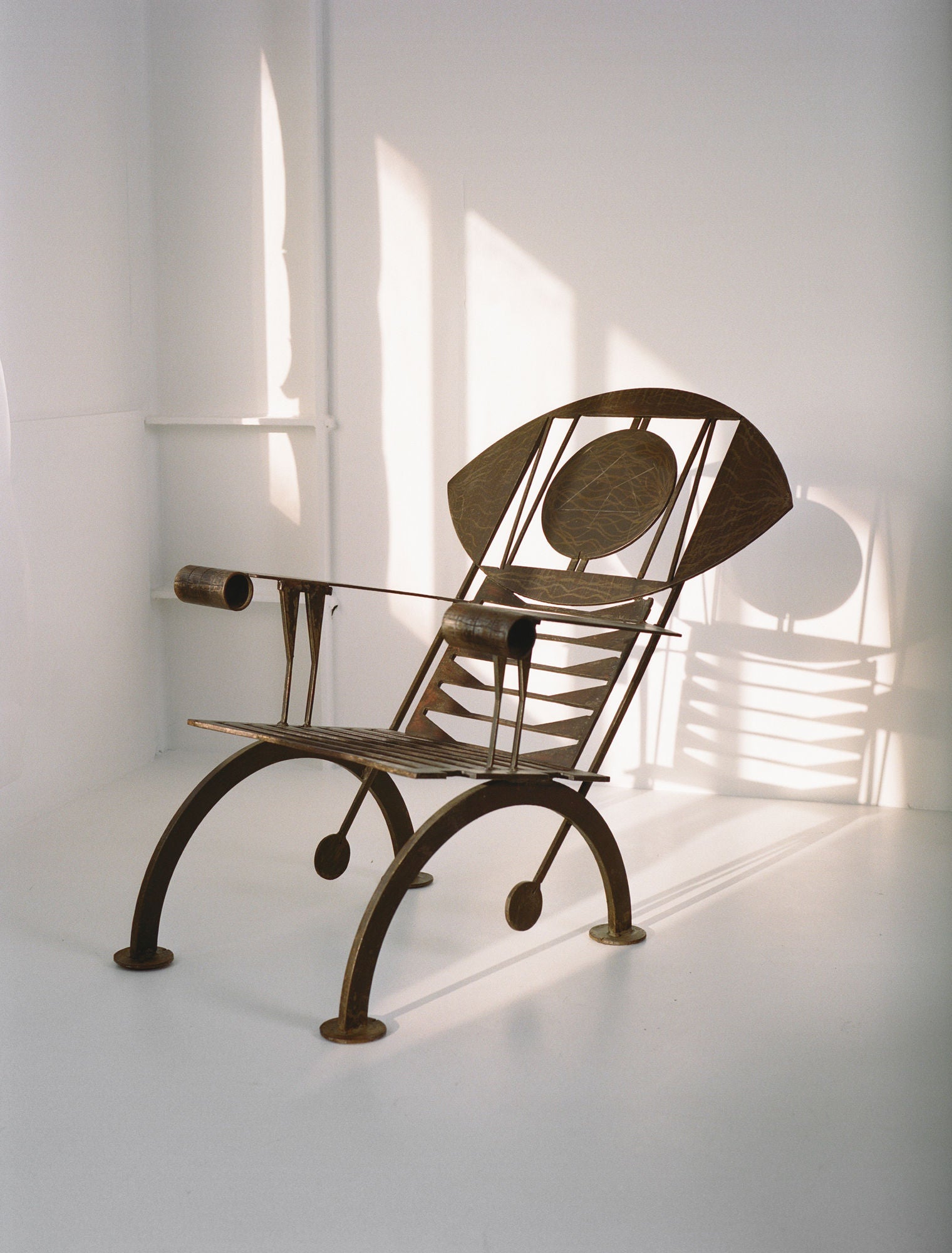 Functional Sculpture / Vintage Artist Arm Chair from Nigeria C. 1960-70 — angled view highlighting metal frame and shadow pat