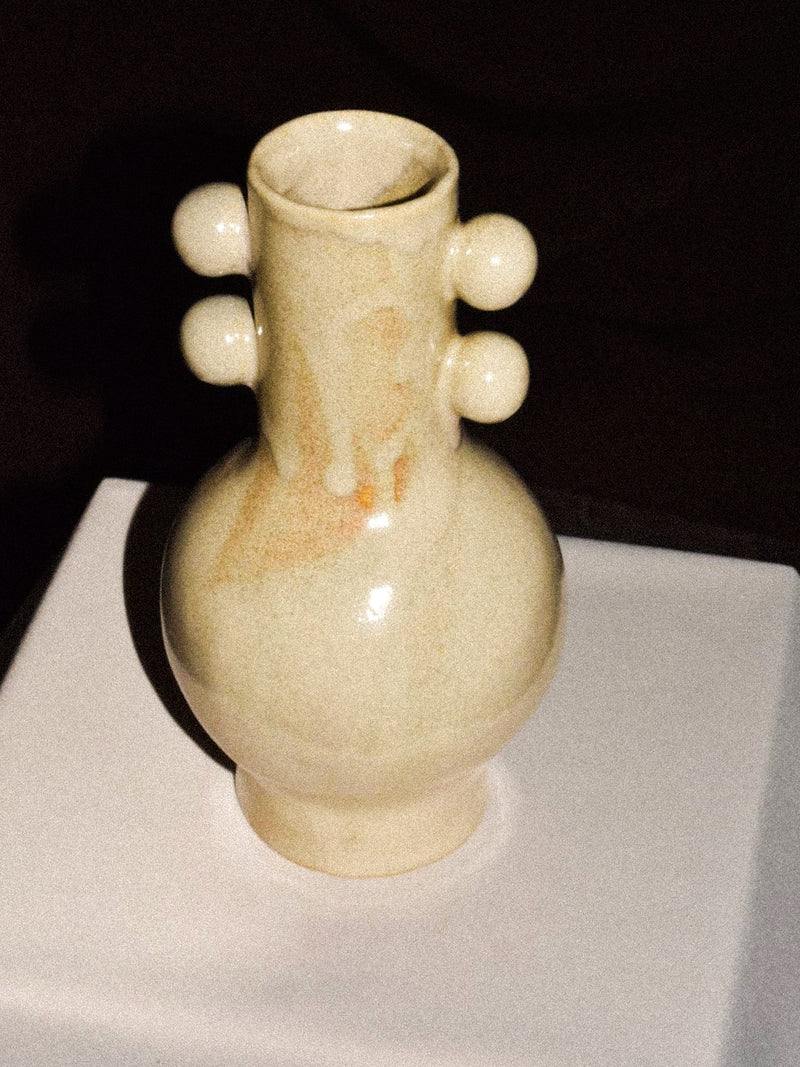 Long Neck Vase — close-up of ceramic surface with round accents