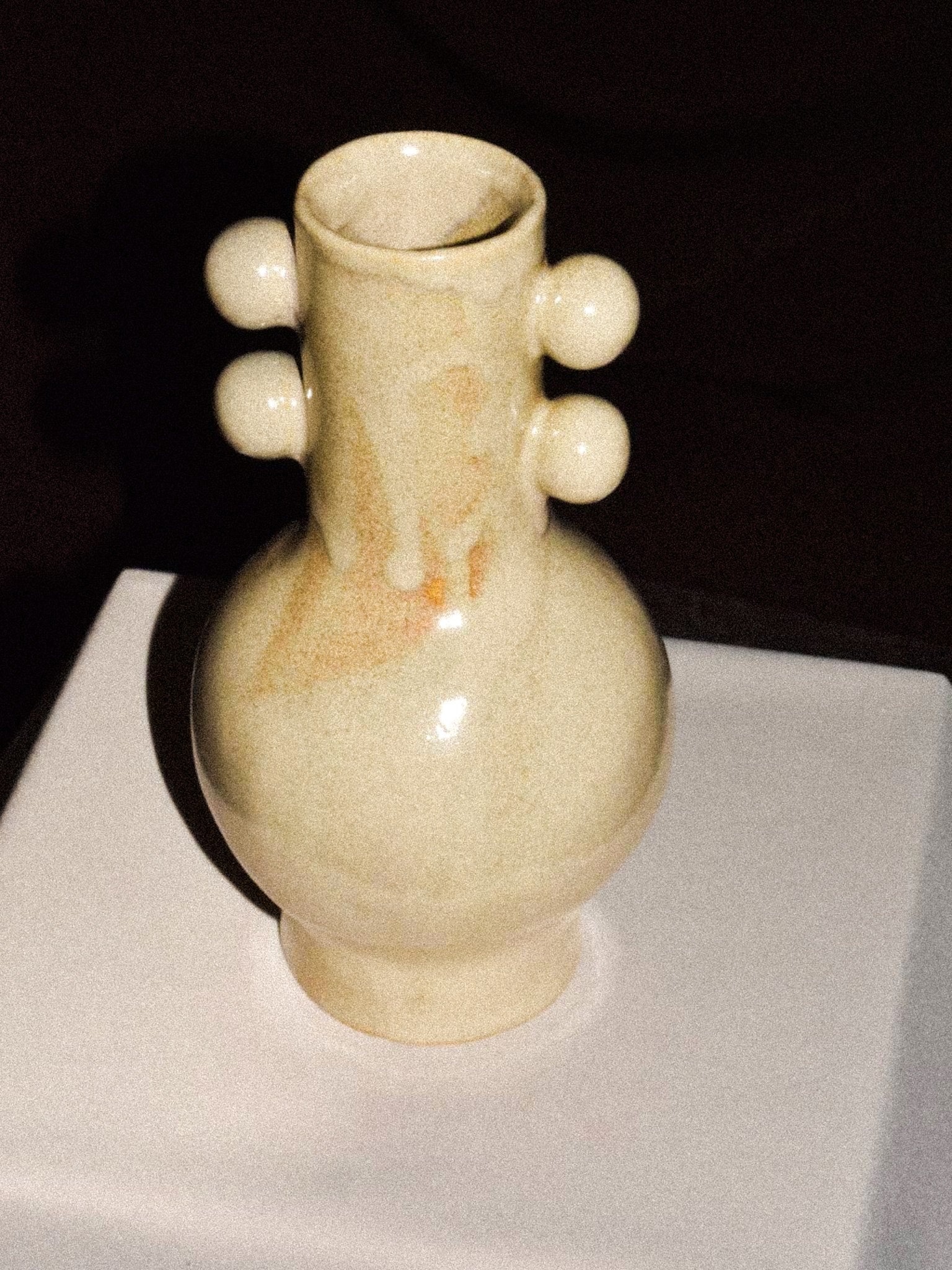 Long Neck Vase — close-up of ceramic surface with round accents