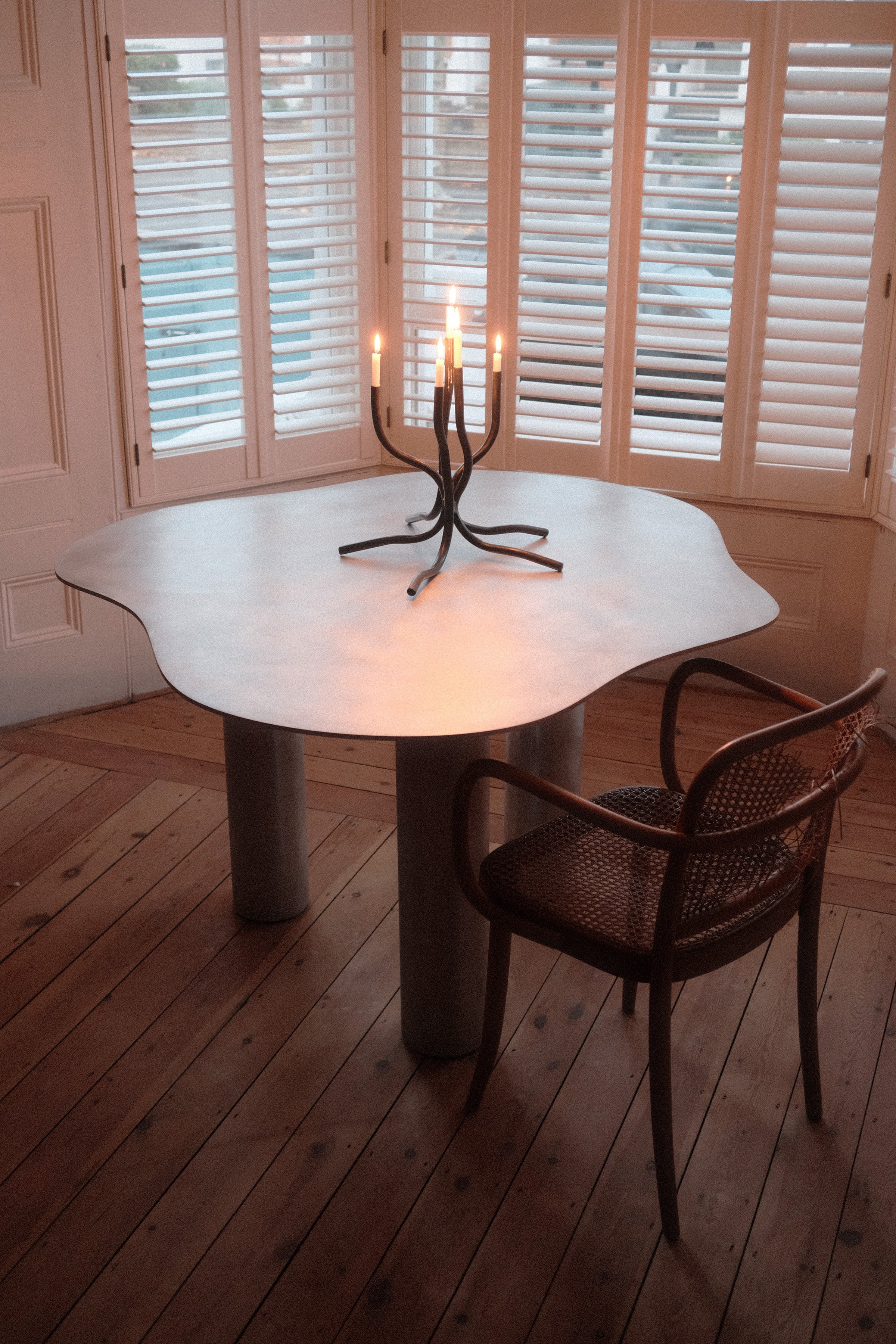 Aluminium Dining Table — close-up of table surface with candle holder