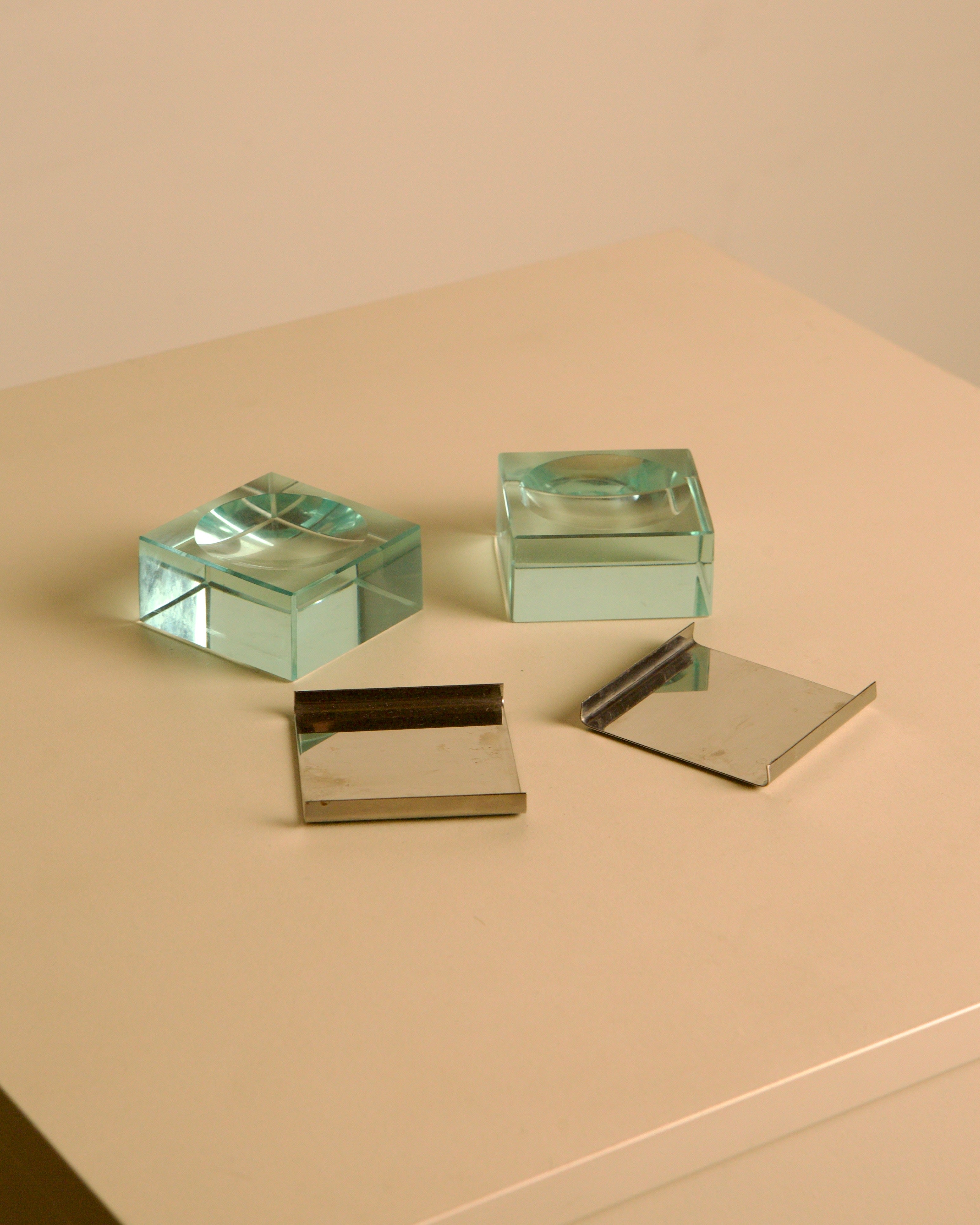 Pair of glass and metal ashtrays by Fontana Arte, 1960s — lifestyle setting