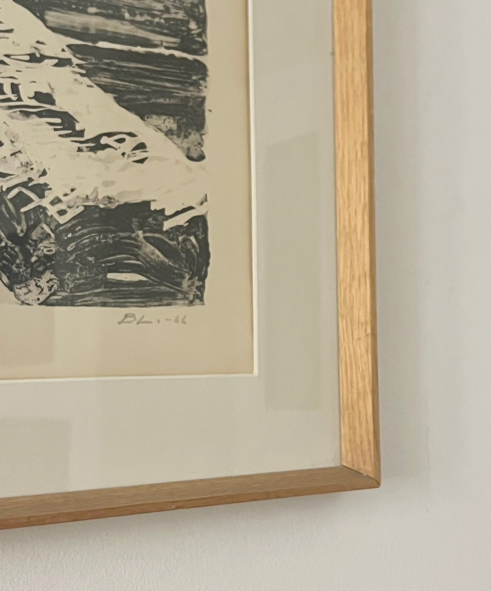 A close-up of the signed Médecine "Large Midcentury Seascape" shows a light wooden frame, beige mat, and black-and-white abstract print. The artist's signature and date appear at the bottom, highlighting this exquisite Scandinavian etching.
