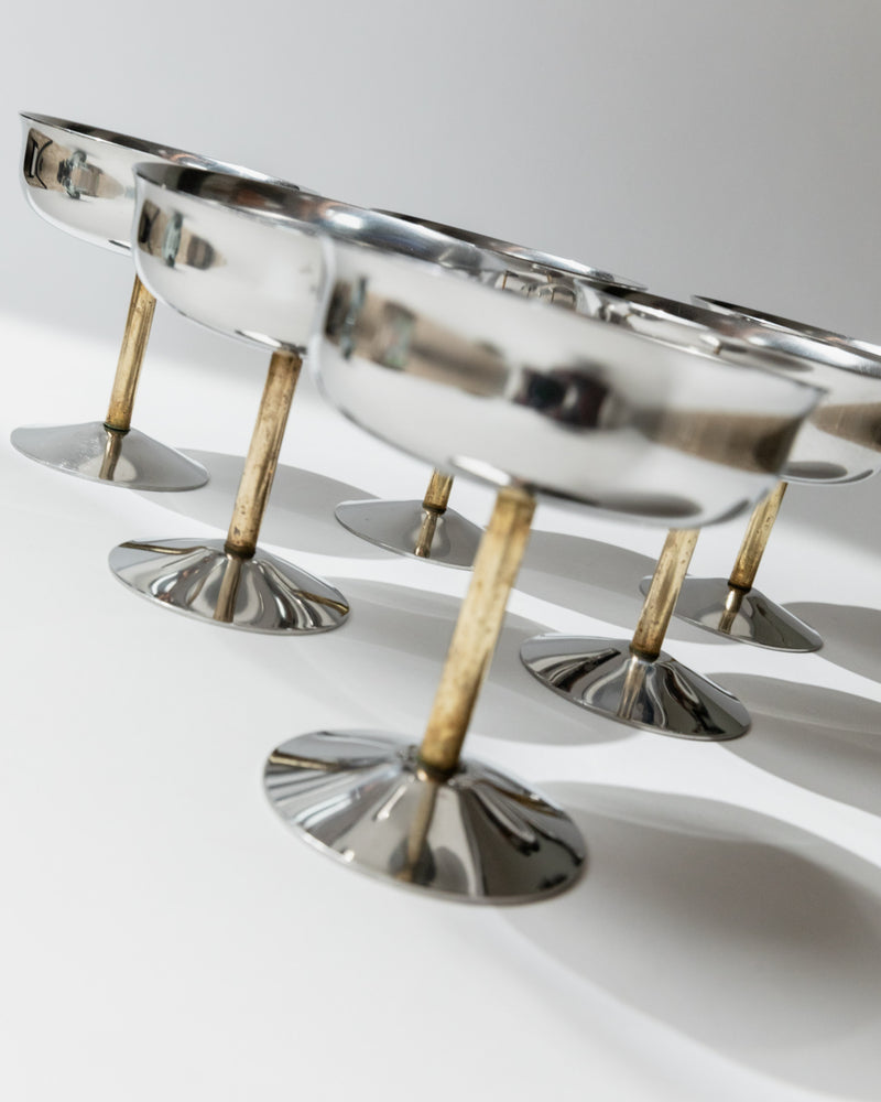 Detail view of golden stems supporting vintage champagne coupes