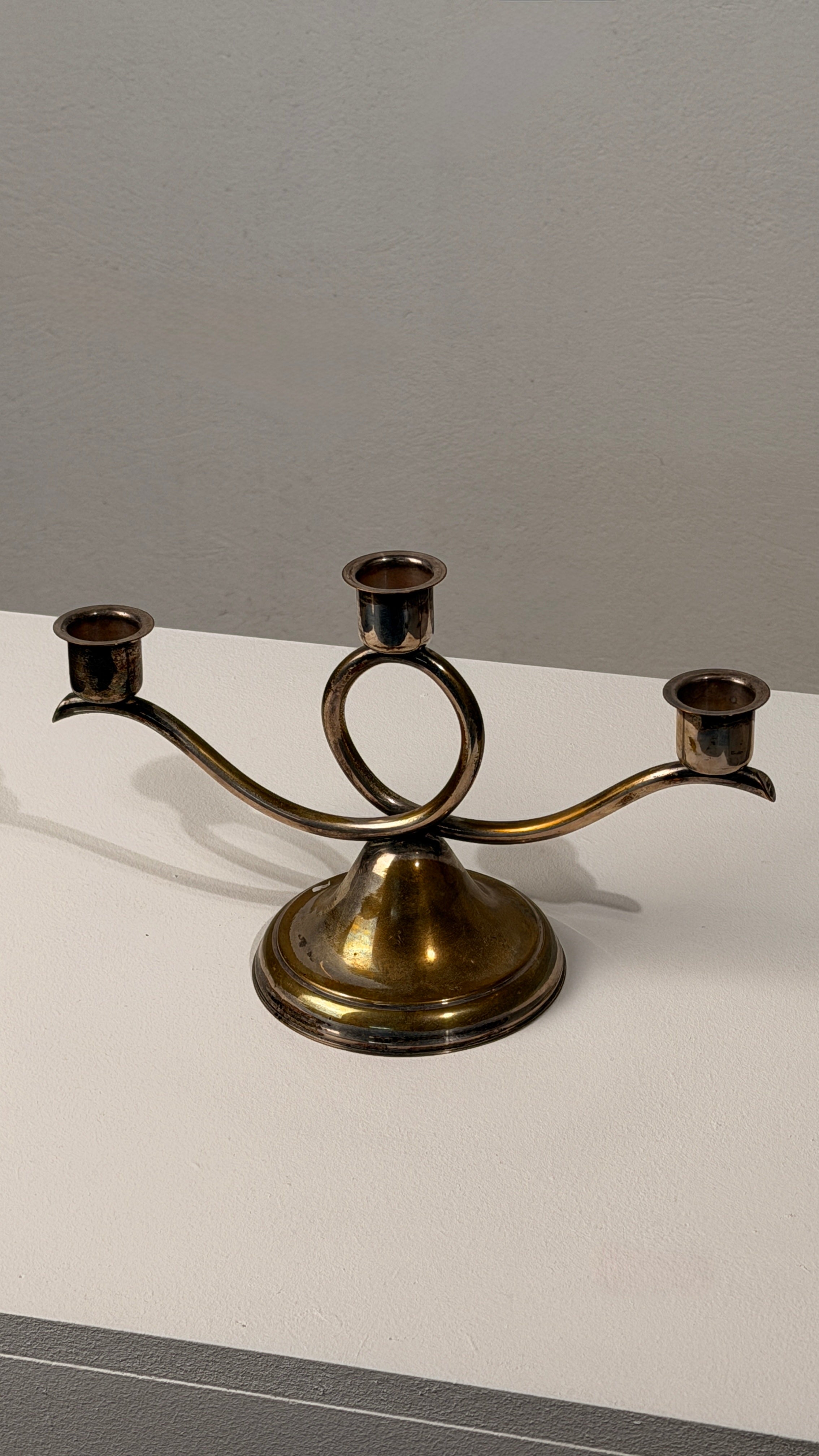 Silvered Metal Candelabra, France, 20th Century — close-up of three candle holders on a flat surface