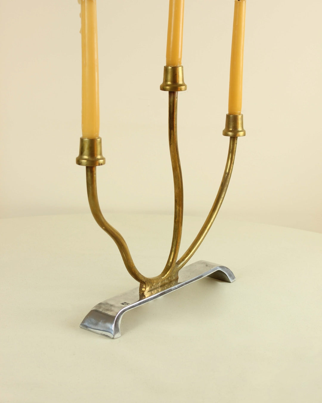 Brutalist Candleholder — angled view on round table with brass base