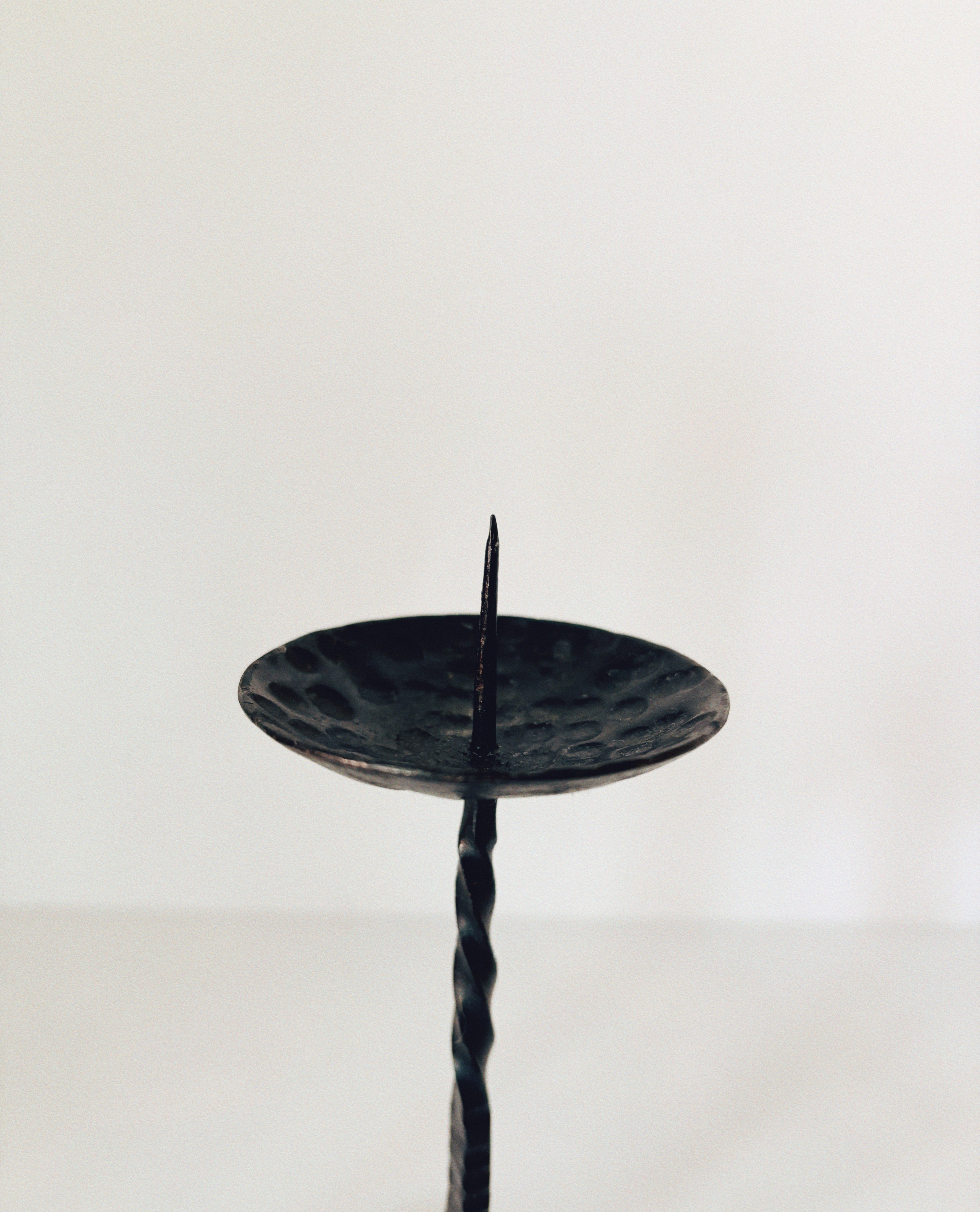 Forged Metal 2 Arm Candlestick, Poland — side view of textured black surface